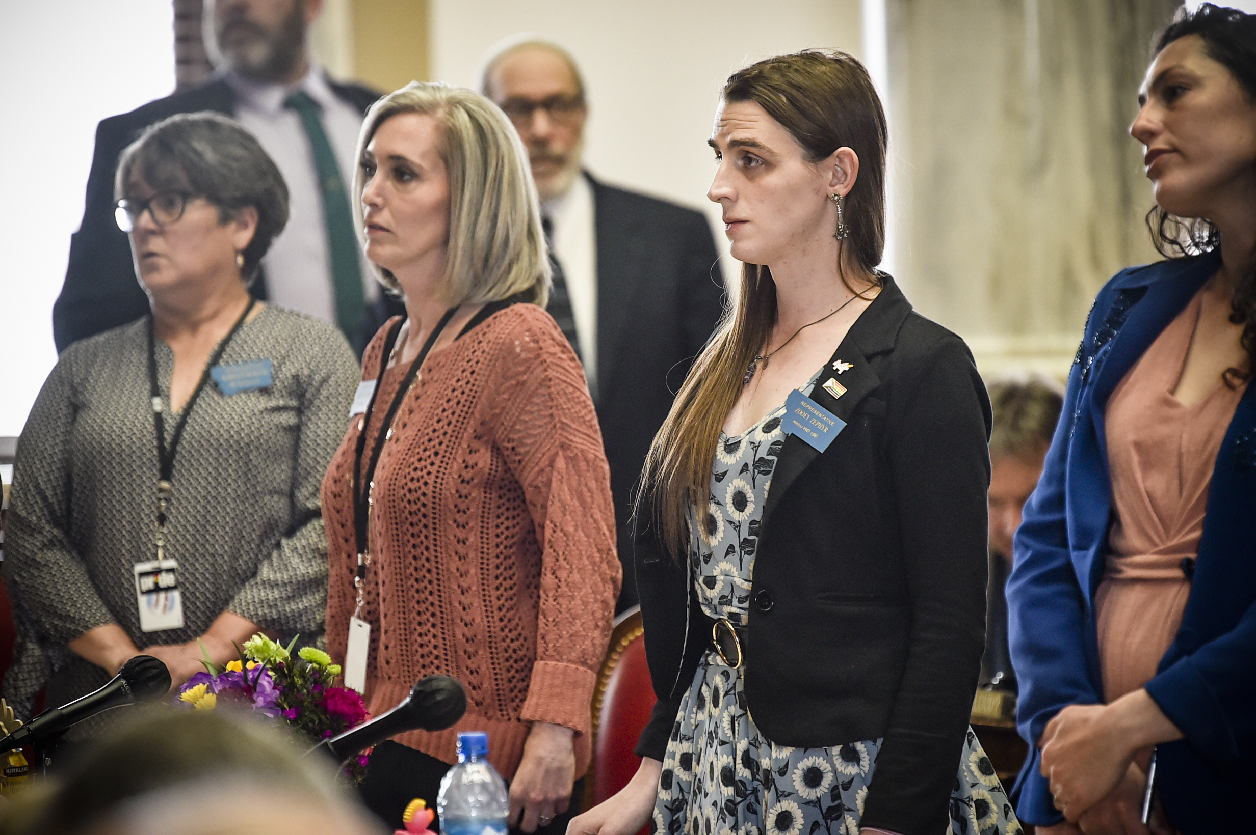 Rep. Zoey Zephyr, D-Missoula, second from right, stands with members of the minority party on the house floor on Thursday, April 20, 2023 at the state capitol in Helena, Mont. (Thom Bridge/Independent Record via AP)