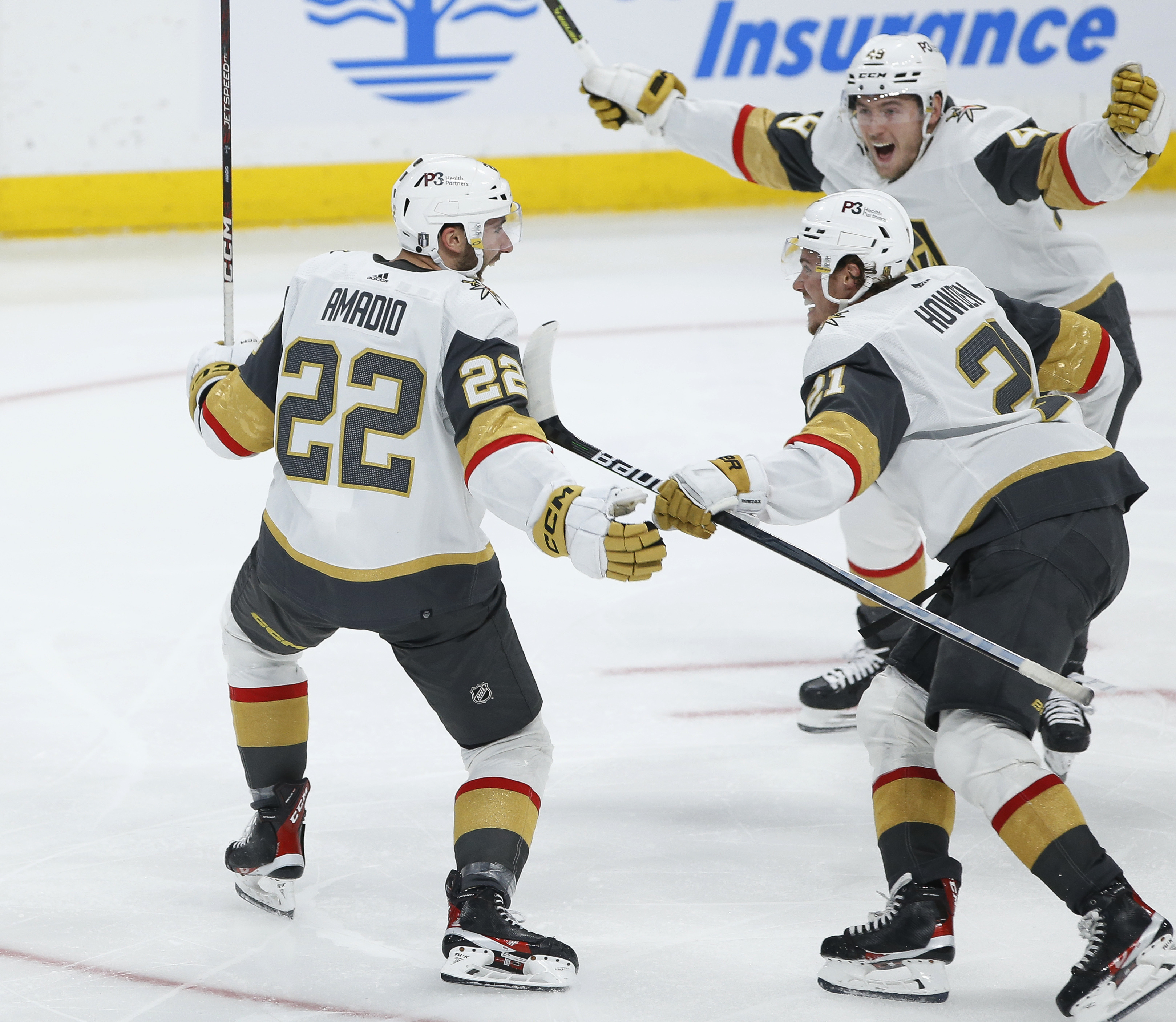 Vegas Golden Knights' Michael Amadio (22), Brett Howden (21) and Ivan Barbashev (49) celebrate Amadio's goal against the Winnipeg Jets in the second overtime in Game 3 of an NHL hockey Stanley Cup first-round playoff series in Winnipeg, Manitoba, Saturday, April 22, 2023. (John Woods/The Canadian Press via AP)