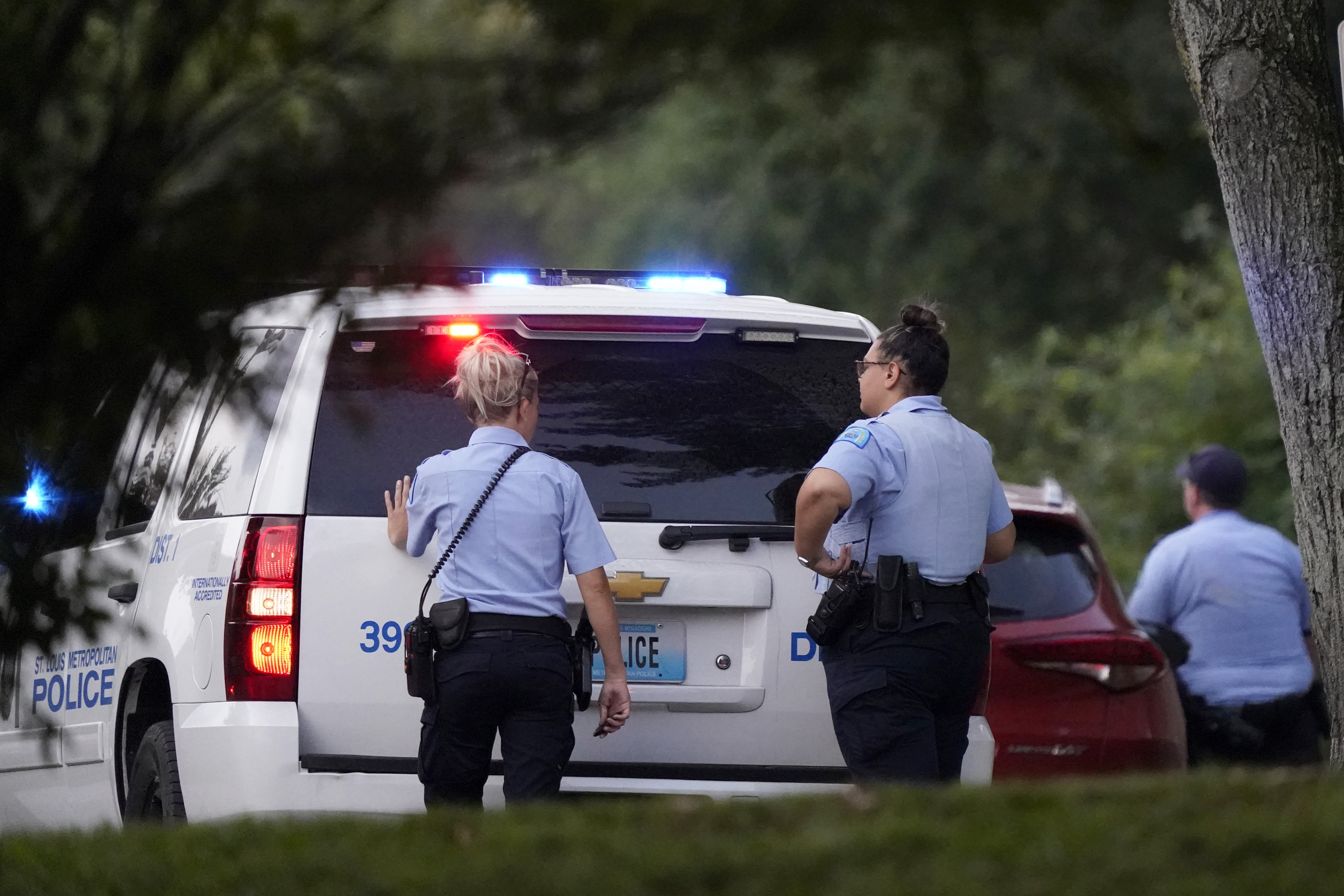 FILE - Police take up positions near the scene of a shooting Saturday, Aug. 29, 2020, in St. Louis. Ten years after gaining local control of its police for the first time since the Civil War, the city of St. Louis has even more murders than before — and Missouri lawmakers are again considering a state takeover of the police force. (AP Photo/Jeff Roberson, File)