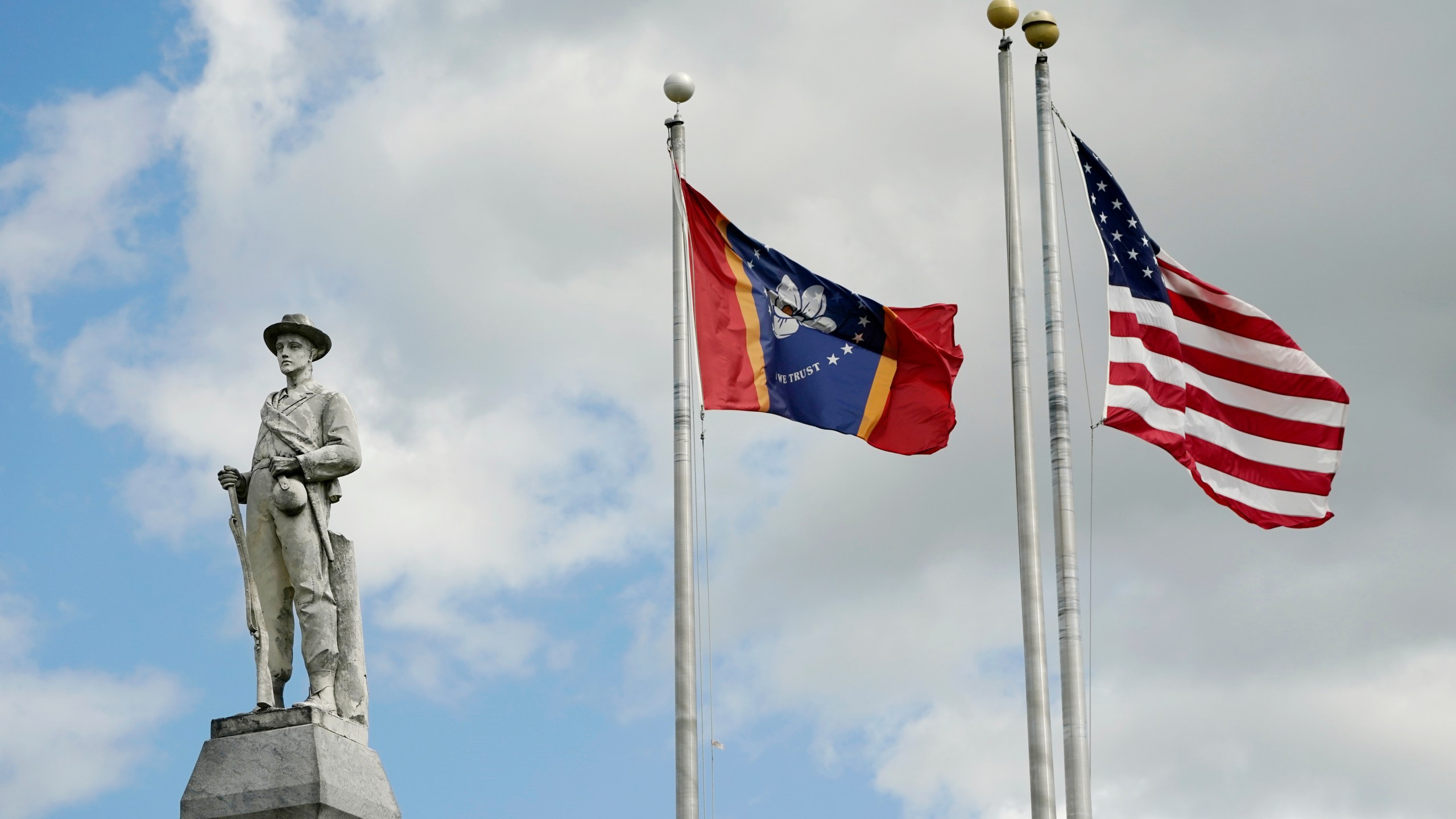 FILE - The Mississippi state and U.S. flags fly near the Rankin County Confederate Monument in the downtown square of Brandon, Miss., on March 3, 2023. Mississippi and Alabama closed most government offices Monday, April 24, for Confederate Memorial Day as efforts have stalled to abolish state holidays that honor the old Confederacy. (AP Photo/Rogelio V. Solis, File)