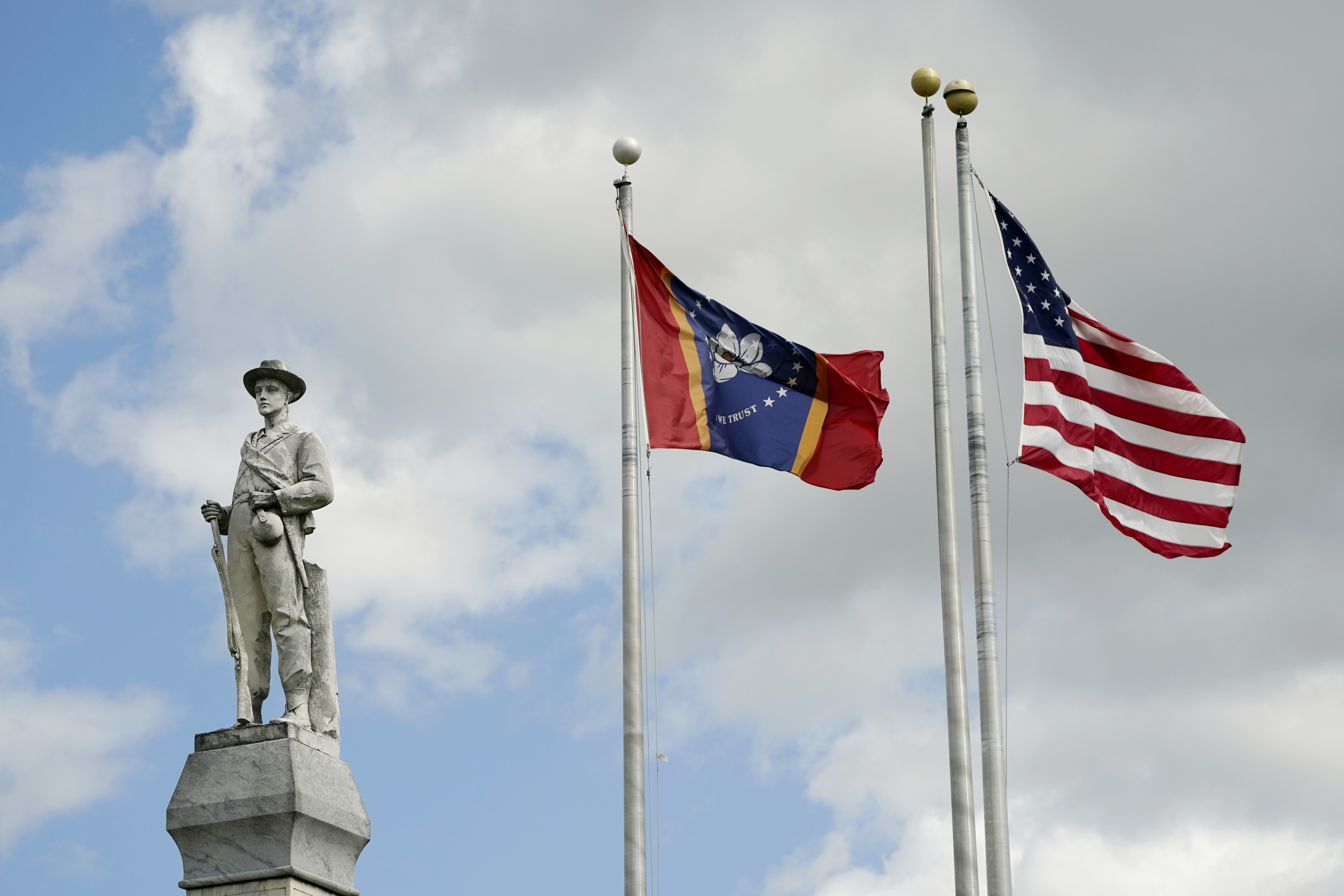 FILE - The Mississippi state and U.S. flags fly near the Rankin County Confederate Monument in the downtown square of Brandon, Miss., on March 3, 2023. Mississippi and Alabama closed most government offices Monday, April 24, for Confederate Memorial Day as efforts have stalled to abolish state holidays that honor the old Confederacy. (AP Photo/Rogelio V. Solis, File)