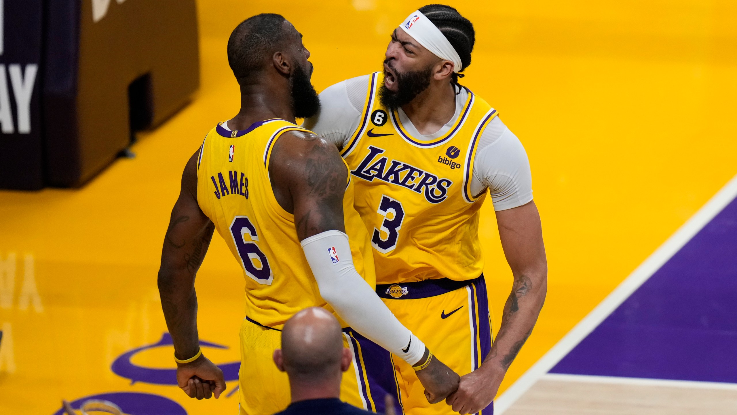 Los Angeles Lakers' LeBron James (6) and Anthony Davis (3) celebrate a basket by James in overtime in Game 4 of a first-round NBA basketball playoff series against the Memphis Grizzlies Monday, April 24, 2023, in Los Angeles. The Lakers won 117-111. (AP Photo/Jae C. Hong)