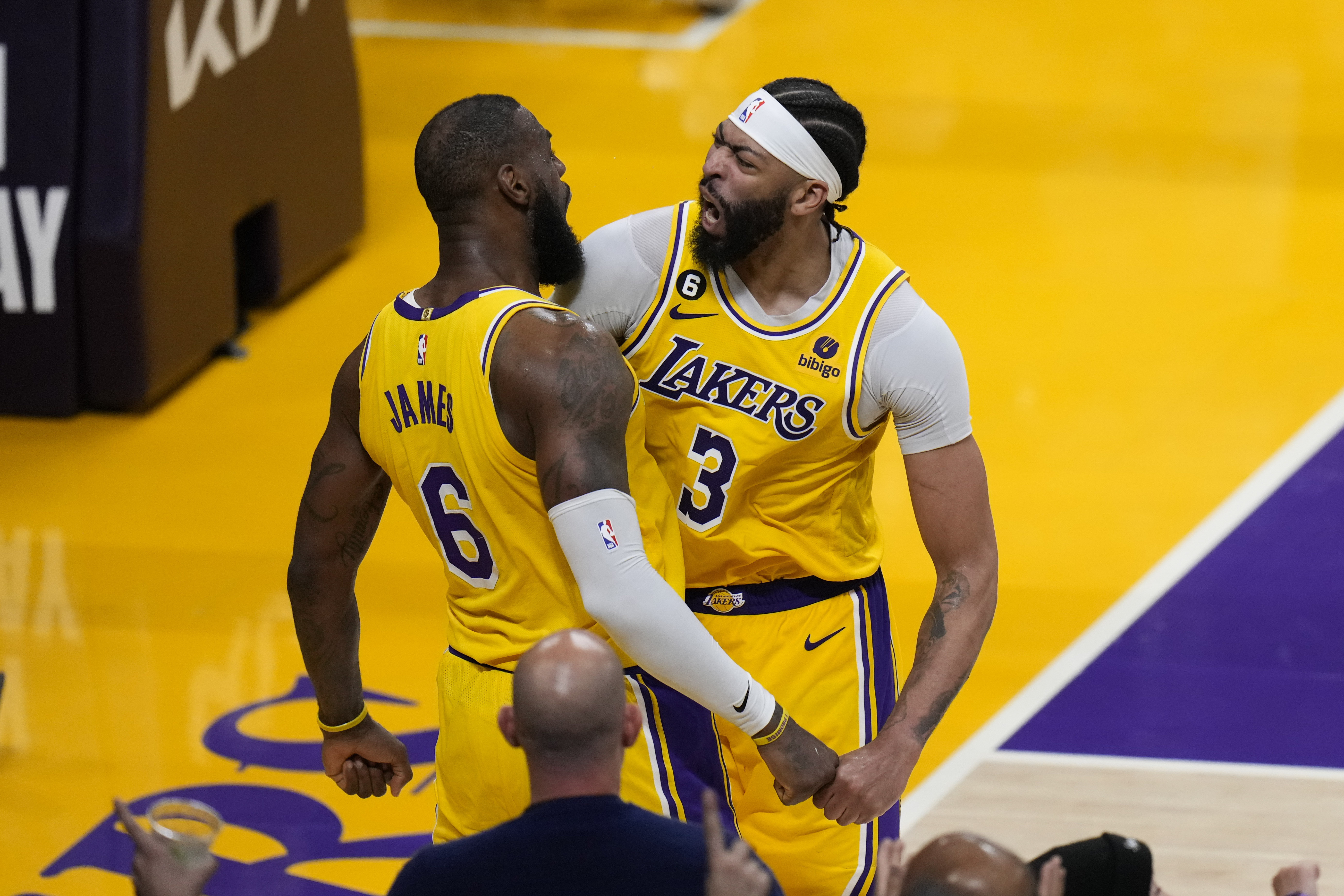 Los Angeles Lakers' LeBron James (6) and Anthony Davis (3) celebrate a basket by James in overtime in Game 4 of a first-round NBA basketball playoff series against the Memphis Grizzlies Monday, April 24, 2023, in Los Angeles. The Lakers won 117-111. (AP Photo/Jae C. Hong)