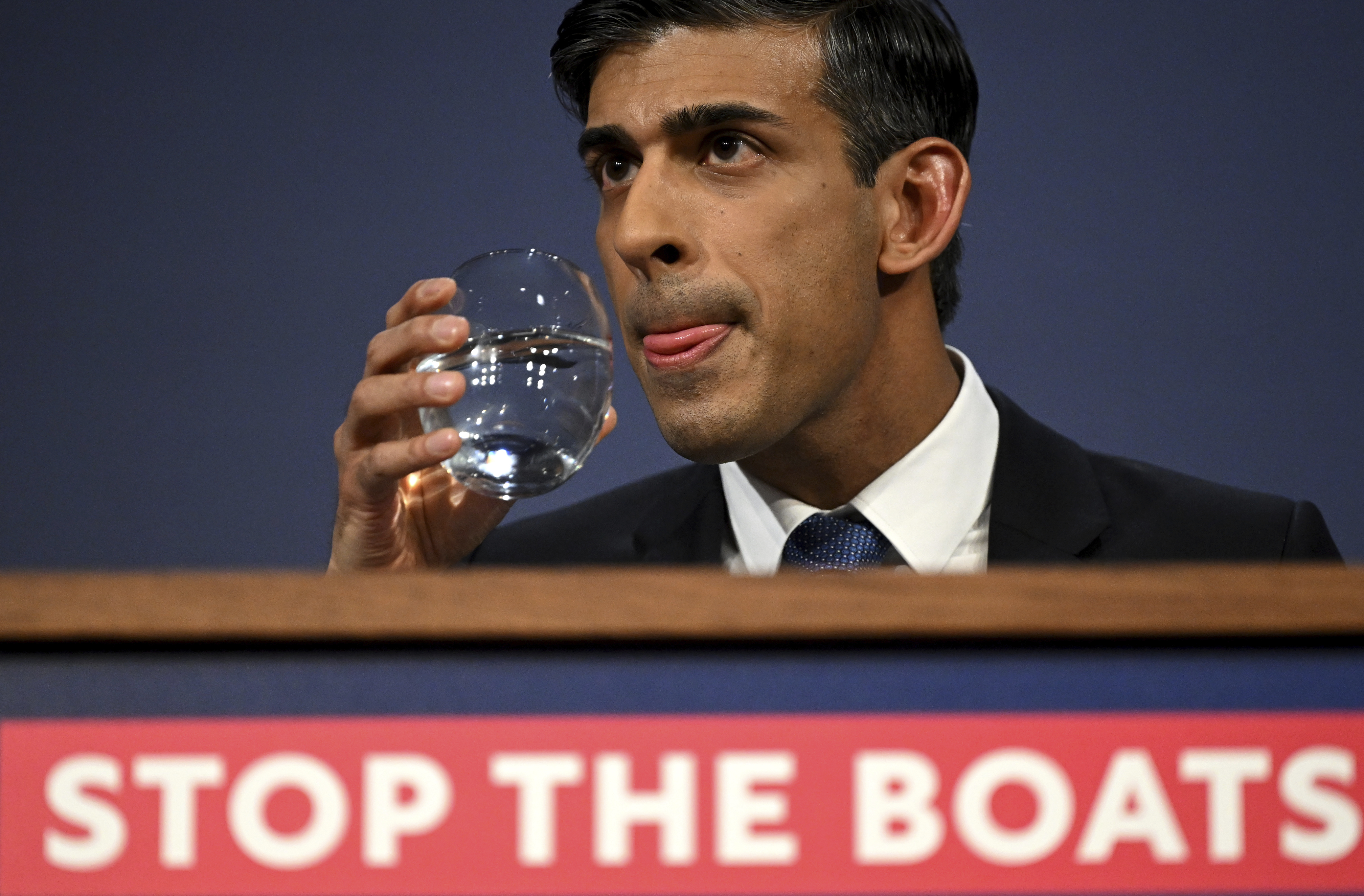 FILE - Britain's Prime Minister Rishi Sunak prepares to take a sip of water during a press conference following the launch of new legislation on migrant channel crossings at Downing Street, London, Tuesday, March 7, 2023. A sweeping British bill that will dramatically curb migrants’ ability to seek asylum in the U.K. is duel to be approved by lawmakers on Wednesday, April 26, 2023, despite critics’ allegations that it breaks international law. (Leon Neal/Pool Photo via AP, File)