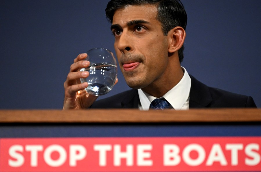 FILE - Britain's Prime Minister Rishi Sunak prepares to take a sip of water during a press conference following the launch of new legislation on migrant channel crossings at Downing Street, London, Tuesday, March 7, 2023. A sweeping British bill that will dramatically curb migrants’ ability to seek asylum in the U.K. is duel to be approved by lawmakers on Wednesday, April 26, 2023, despite critics’ allegations that it breaks international law. (Leon Neal/Pool Photo via AP, File)