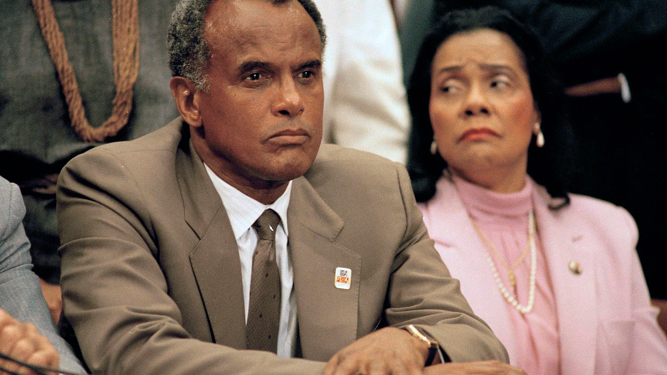 FILE - Entertainer and activist Harry Belafonte, and Coretta Scott King, widow of slain civil rights leader Dr. Martin Luther King, Jr., listen to a speaker during an anti-apartheid demonstration on Capitol Hill in Washington on Aug. 12, 1985. Belafonte died Tuesday of congestive heart failure at his New York home. He was 96. (AP Photo/Lana Harris, File)