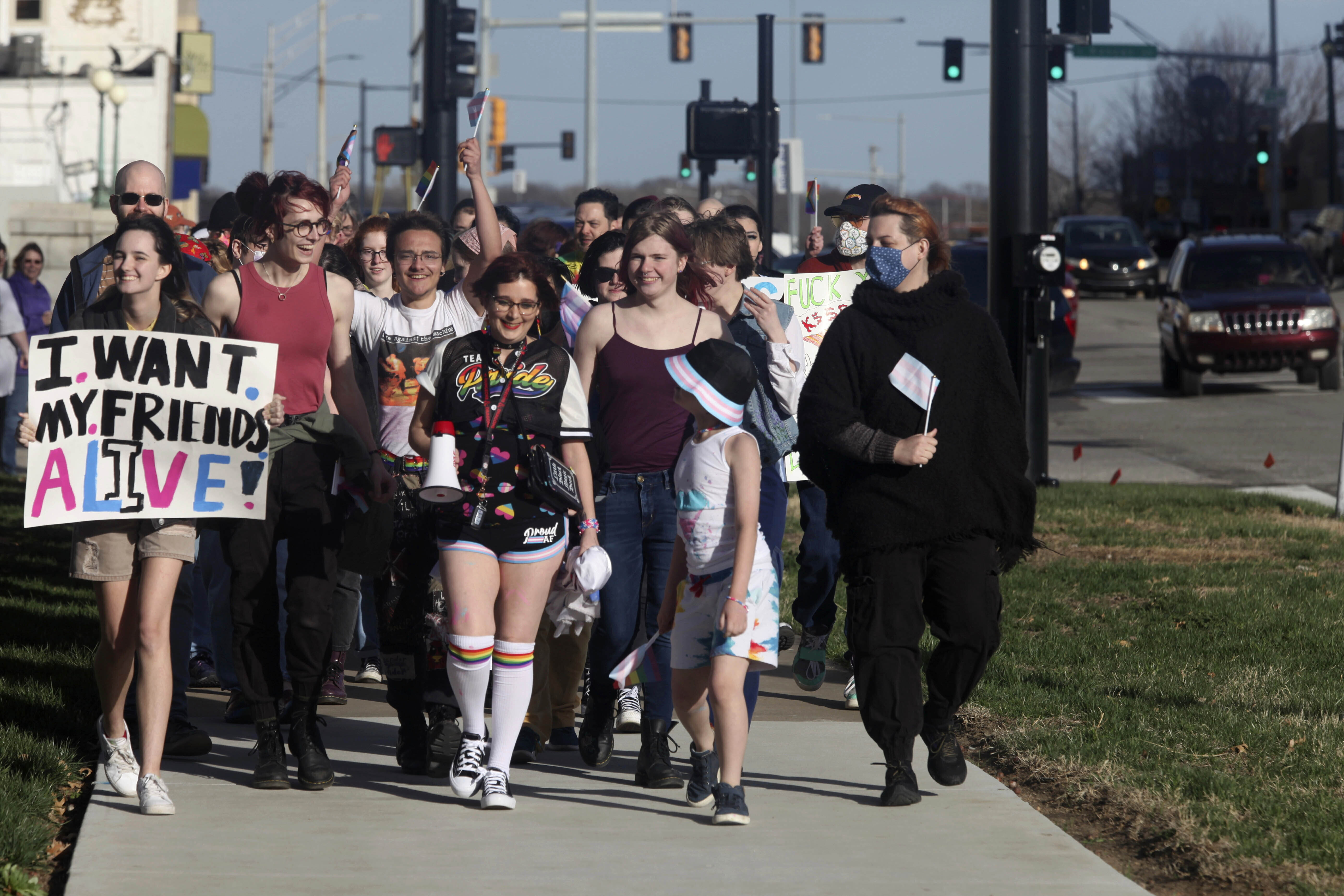 More than 100 people, many of them transgender youth, march around the Kansas Statehouse on the annual Transgender Day of Visibility, Friday, March 31, 2023, in Topeka, Kan. While the event was a celebration of transgender identity, it also was a protest against proposals before the Kansas Legislature to roll back transgender rights. (AP Photo/John Hanna)