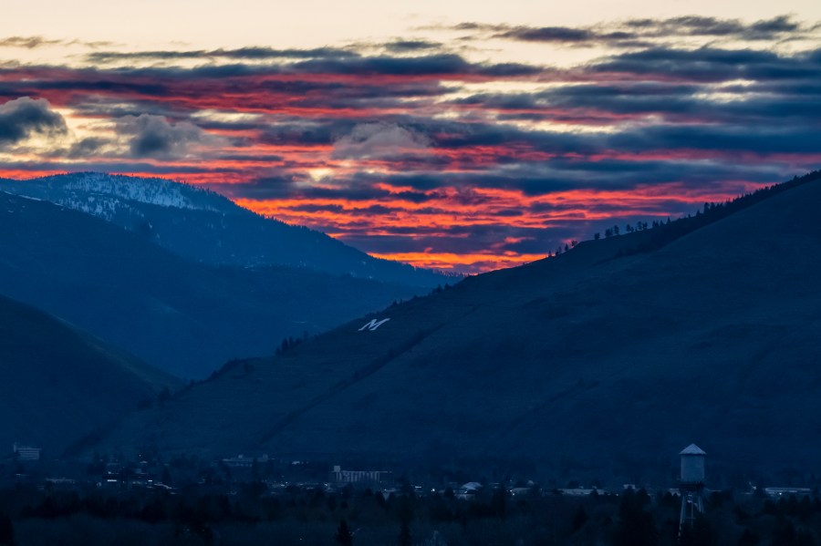 The sun rises beyond Mount Sentinel and downtown Missoula, Mont., Tuesday, April 25, 2023. It was little surprise that Missoula, a college town where pride flags are a common sight, sent Zooey Zephyr to the state legislature. Zephyr, the first openly transgender legislator in Montana’s history, was barred last week from speaking on the floor of the legislature by the Republican majority. (AP Photo/Tommy Martino)