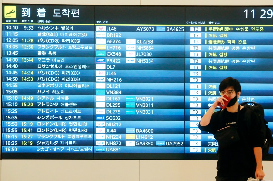 FILE - A passenger arrives from overseas at the arrivals hall of Haneda international airport in Tokyo, Nov. 8, 2021. Japan will lift its coronavirus border controls and no longer require entrants to show pre-departure negative tests and records of triple vaccinations beginning Saturday, April 28, 2023, as the country’s Golden Week holiday season begins and a large influx of foreign tourists are expected. (AP Photo/Koji Sasahara, File)