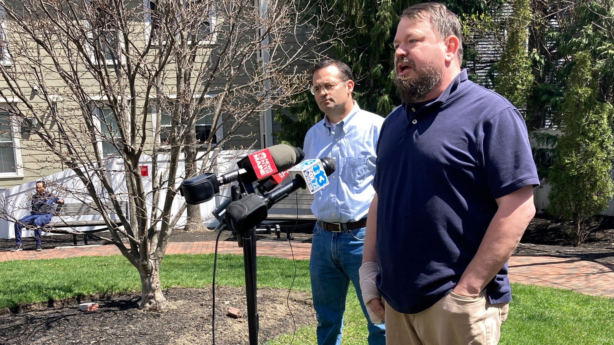 Sean Halsey, right, who was injured along with his children in a shooting in Maine last week, speaks at a news conference outside Maine Medical Center in Portland, Maine, Friday, April 28, 2023. Halsey said he and his children are recovering from their injuries and grateful for the support they've received from the community. A 34-year-old man confessed last week to four killings at a home in Bowdoin and injuring the three people while shooting at vehicles on Interstate 295 in Yarmouth, police have said. (AP Photo/Patrick Whittle)