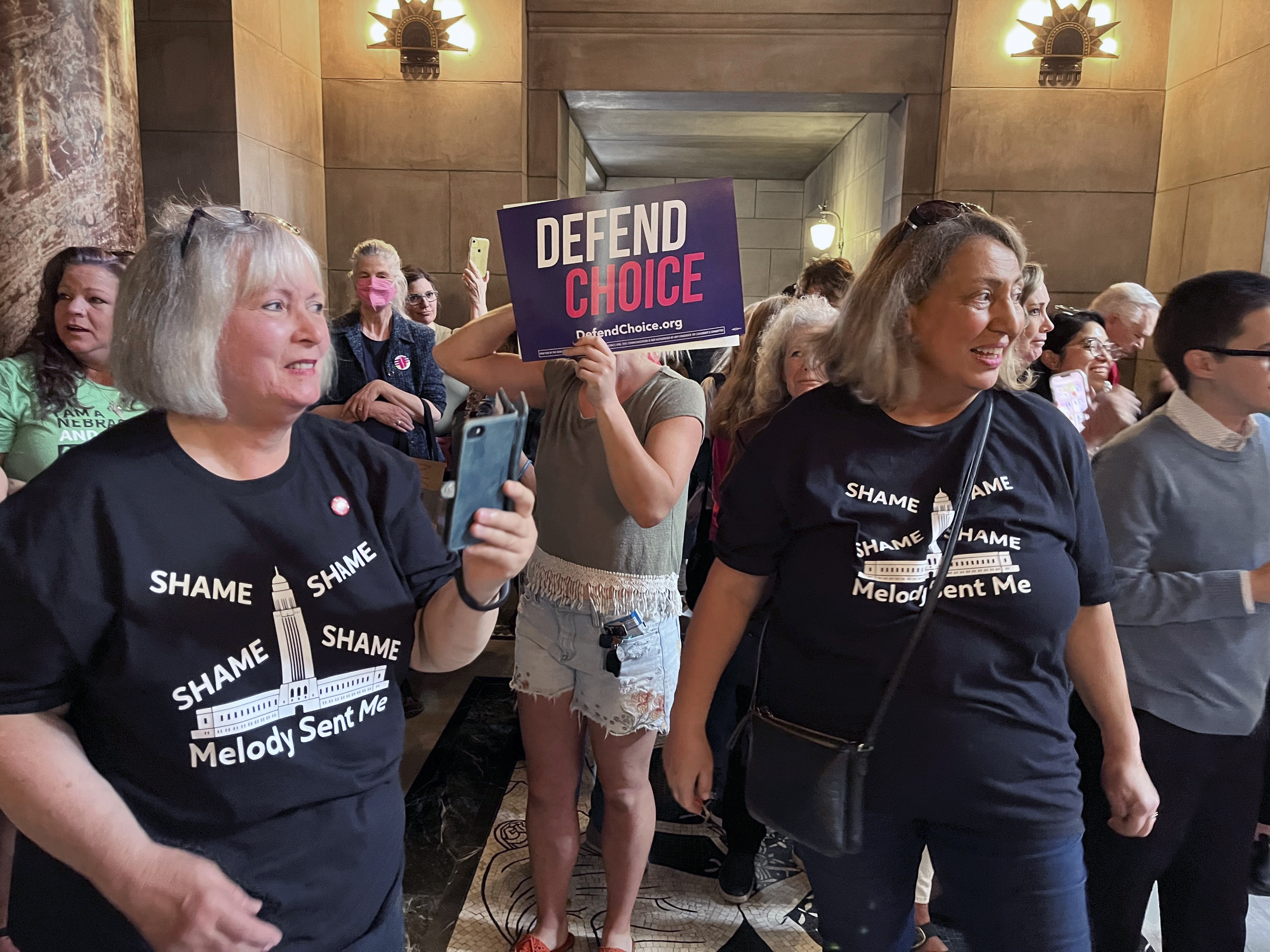 Pat Neal, left, and Ann Fintell, both of Lincoln, celebrate in the Nebraska Capitol rotunda after the failure of a bill that would have banned abortion around the sixth week of pregnancy, Thursday, April 27, 2023 in Lincoln, Neb. The bill is now likely dead for the year, leaving in place a 2010 law that bans abortions at 20 weeks. (AP Photo/Margery Beck)