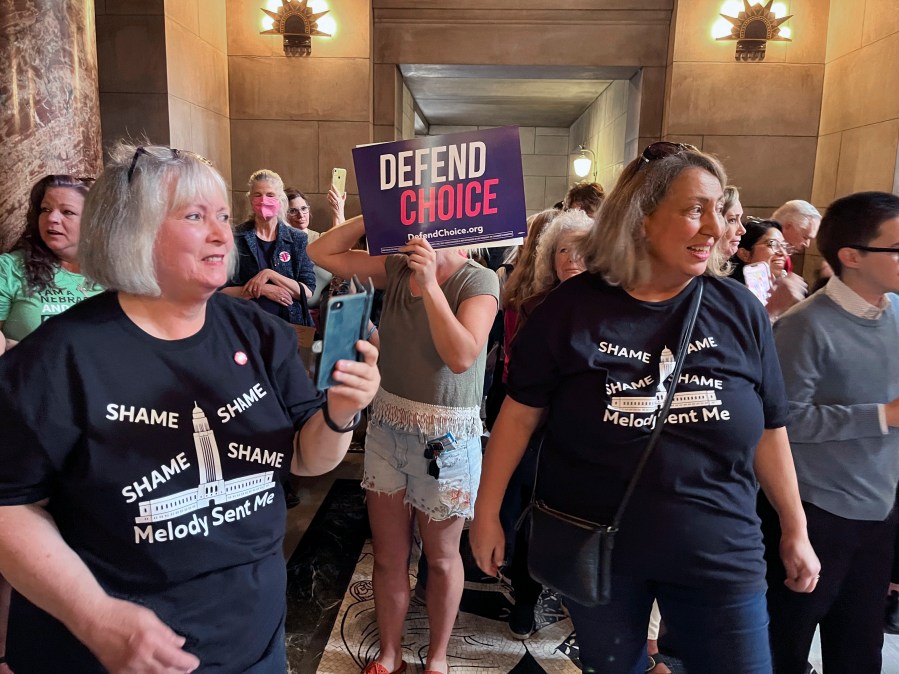 Pat Neal, left, and Ann Fintell, both of Lincoln, celebrate in the Nebraska Capitol rotunda after the failure of a bill that would have banned abortion around the sixth week of pregnancy, Thursday, April 27, 2023 in Lincoln, Neb. The bill is now likely dead for the year, leaving in place a 2010 law that bans abortions at 20 weeks. (AP Photo/Margery Beck)