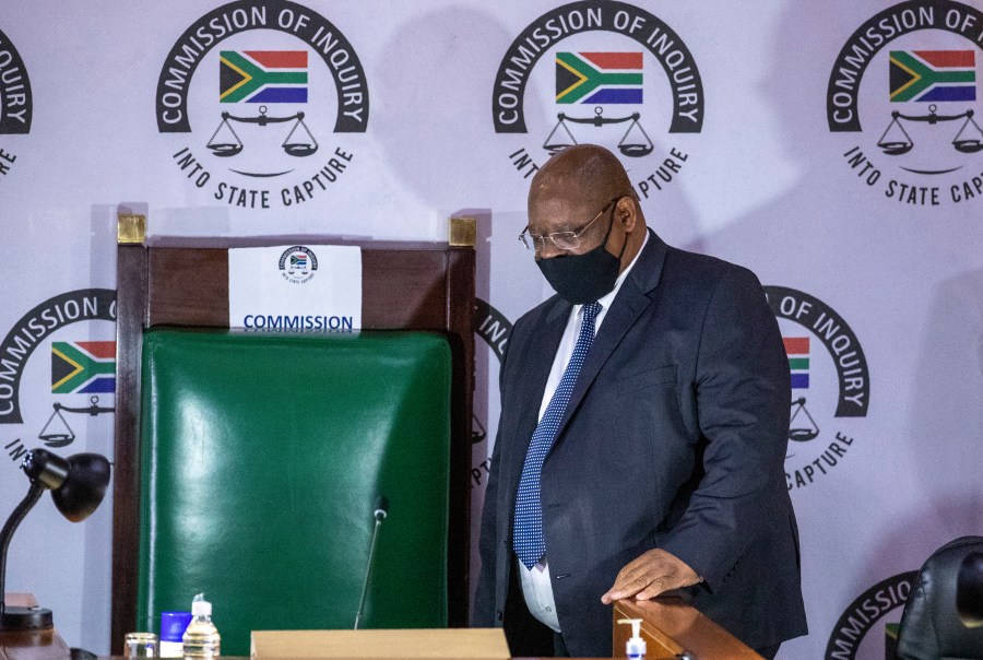 FILE - Judge Raymond Zondo, chairman of the Zondo Commission, a judicial inquiry into government and other high-level corruption in South Africa from 2009-2018 arrives in court, in Johannesburg, South Africa, on Nov. 19, 2020. Anti-corruption groups in South Africa have called for more protection of whistleblowers following recent killings that bore the hallmarks of professional hits. (AP Photo/Themba Hadebe, File)