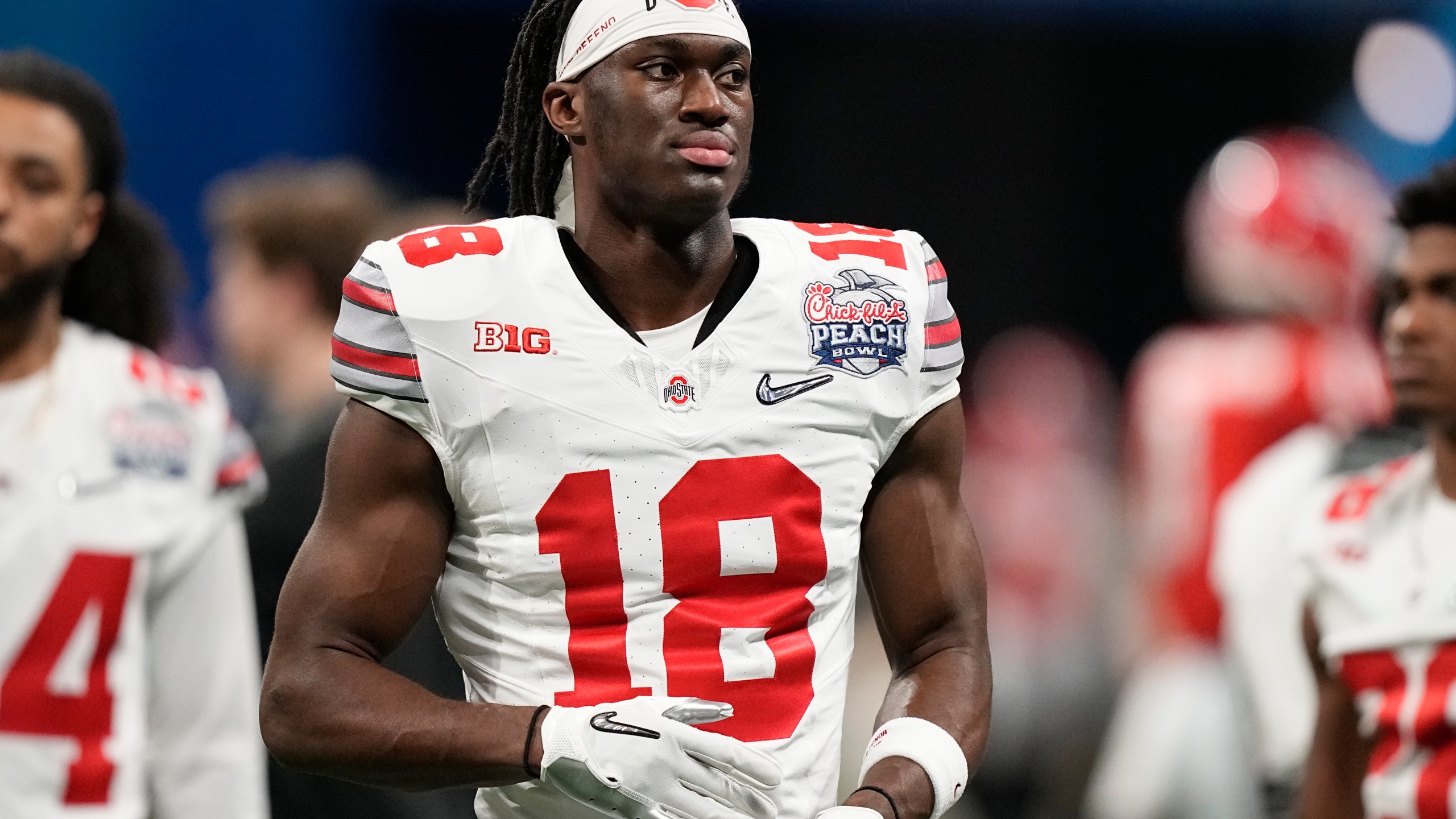 FILE - Ohio State wide receiver Marvin Harrison Jr. (18) warms up before the Peach Bowl NCAA college football semifinal playoff game between Georgia and Ohio State, Saturday, Dec. 31, 2022, in Atlanta. The 2024 NFL draft class could be tank-worthy. With a full season of college football still to be played, two future franchise quarterbacks are already being penciled into the top of draft boards. (AP Photo/Brynn Anderson, File)