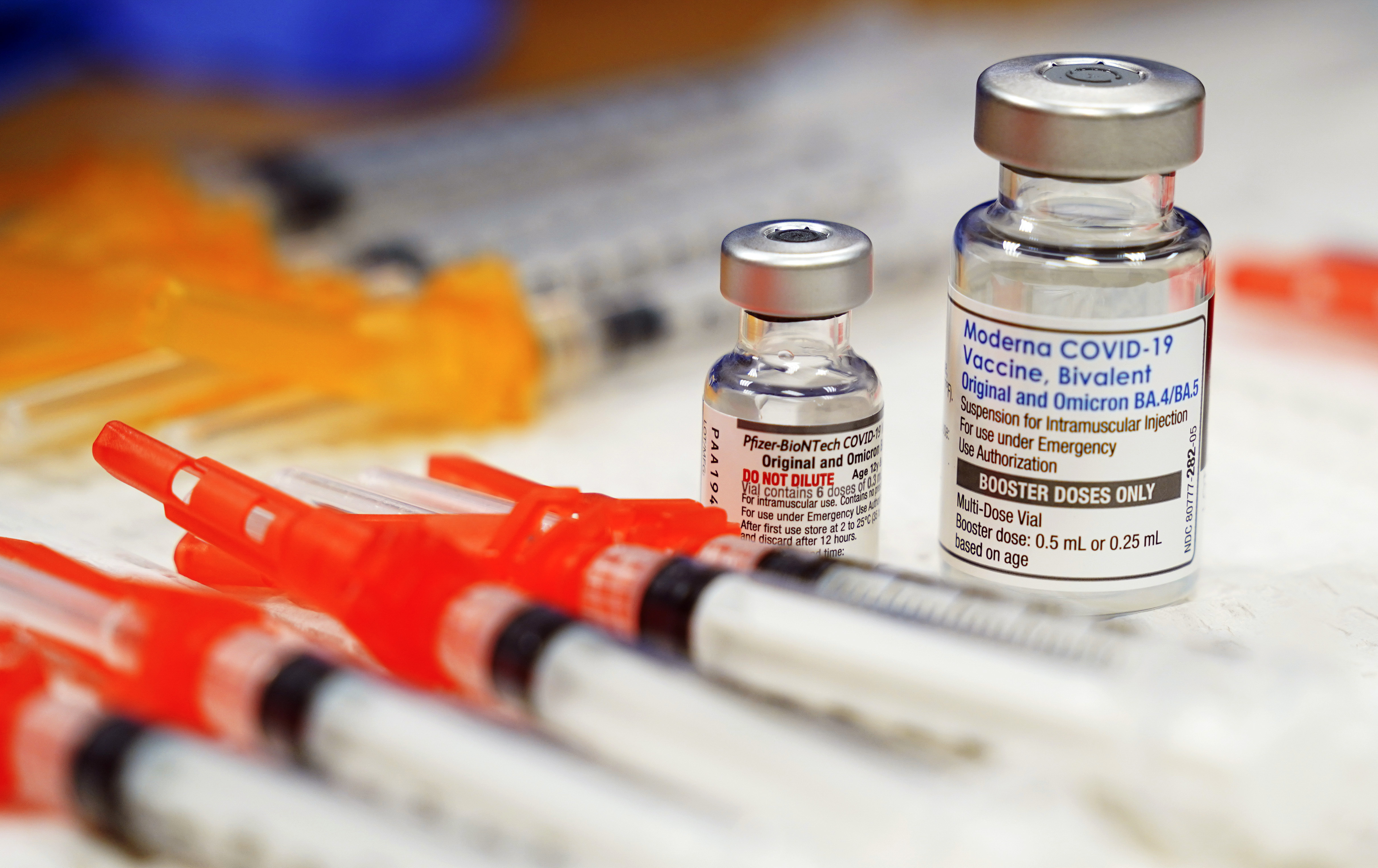 FILE - Pfizer, left, and Moderna bivalent COVID-19 vaccines are readied for use at a clinic, Nov. 17, 2022, in Richmond, Va. The Biden administration will end most of the last remaining federal COVID-19 vaccine requirements next week when the national public health emergency for the coronavirus ends, the White House said Monday, May 1, 2023. (AP Photo/Steve Helber, File)