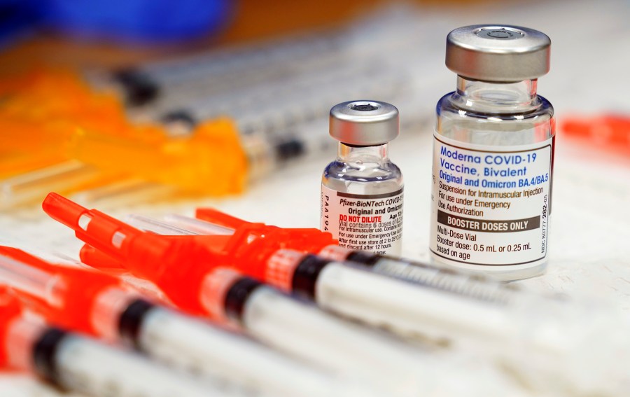 FILE - Pfizer, left, and Moderna bivalent COVID-19 vaccines are readied for use at a clinic, Nov. 17, 2022, in Richmond, Va. The Biden administration will end most of the last remaining federal COVID-19 vaccine requirements next week when the national public health emergency for the coronavirus ends, the White House said Monday, May 1, 2023. (AP Photo/Steve Helber, File)