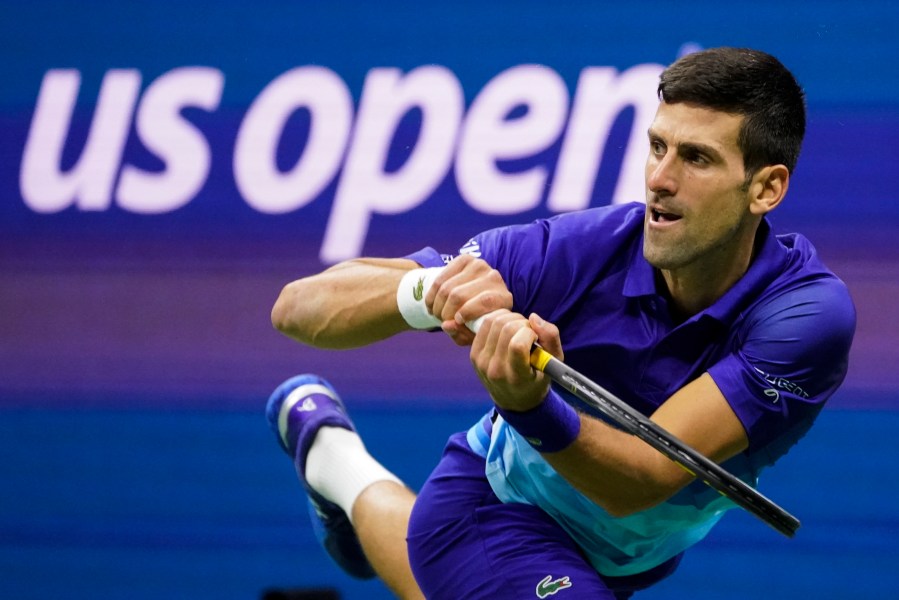 FILE - Novak Djokovic, of Serbia, returns a shot to Alexander Zverev, of Germany, during the semifinals of the U.S. Open tennis championships, Friday, Sept. 10, 2021, in New York. Djokovic can return to the U.S. Open this year after missing the tournament in 2022, because the federal government's COVID-19 vaccination mandate for foreign air travelers will be gone as of next week. (AP Photo/John Minchillo, File)