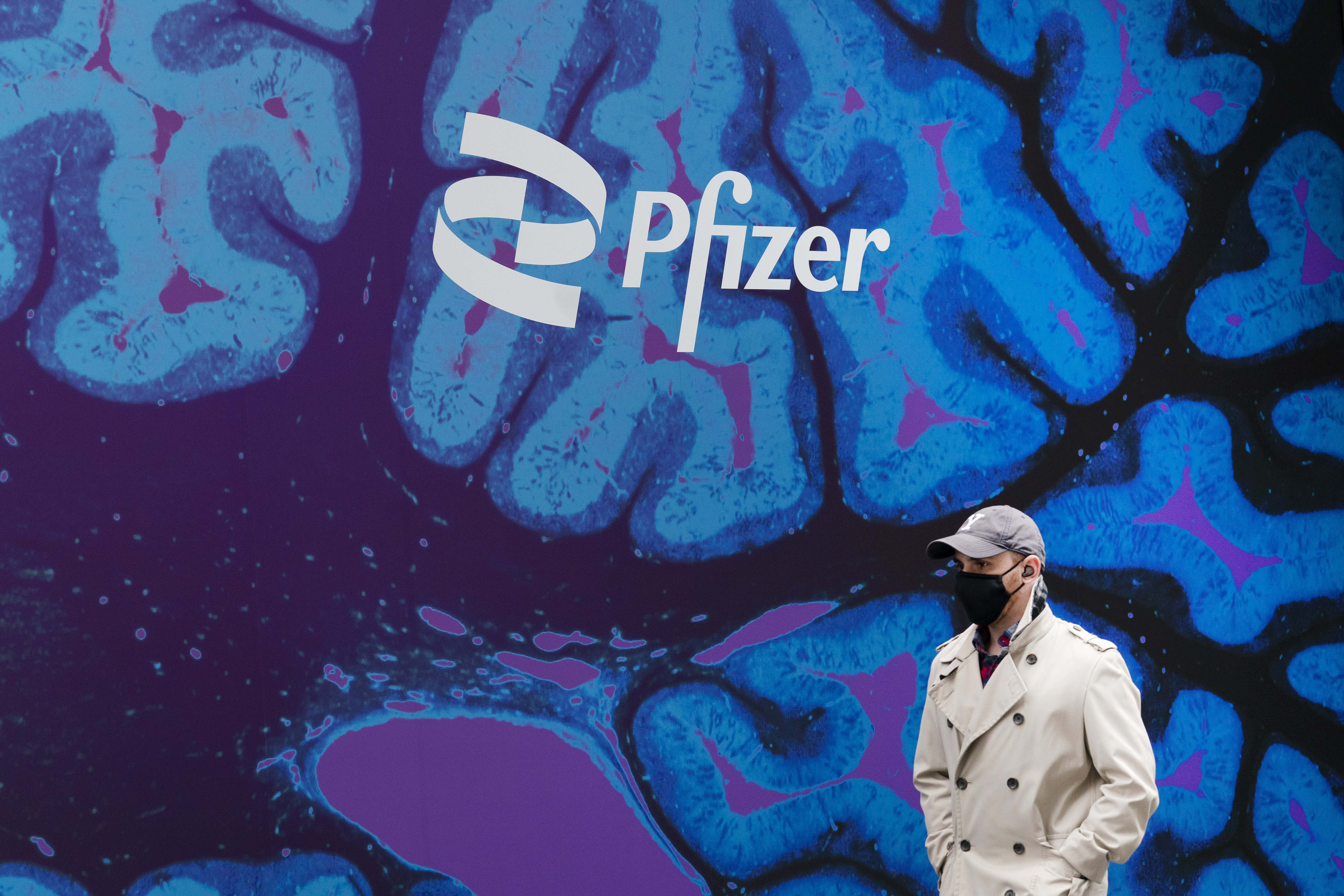 FILE - A man walks by Pfizer headquarters, Friday, Feb. 5, 2021 in New York. Pfizer reports their earnings on Tuesday, May 2, 2023. (AP Photo/Mark Lennihan, File)