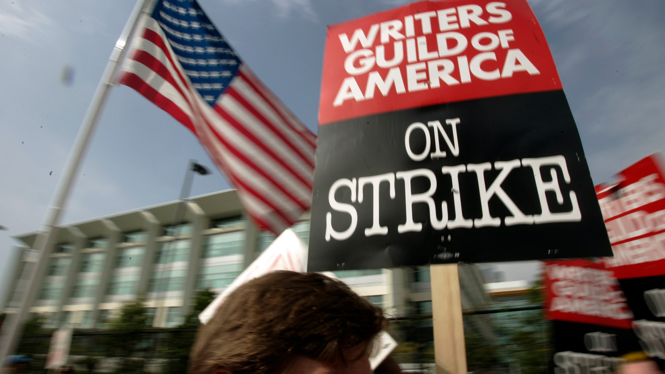 FILE - Writers Guild of America (WGA) writers and others strike against the Alliance of Motion Picture and Television Producers (AMPTP) in a rally at Fox Plaza in Los Angeles' Century City district on Nov. 9, 2007. Television and movie writers on Monday, May 1, 2023, declared that they will launch an industrywide strike for the first time since 2007, as Hollywood girded for a shutdown in a dispute over fair pay in the streaming era. (AP Photo/Reed Saxon, File)