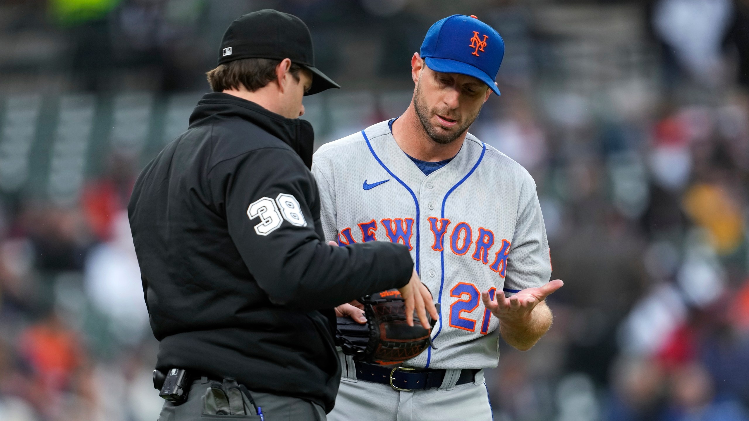 New York Mets pitcher Max Scherzer is checked by umpire Adam Beck on his way to the dugout against the Detroit Tigers after the second inning during the second baseball game of a doubleheader, Wednesday, May 3, 2023, in Detroit. (AP Photo/Paul Sancya)