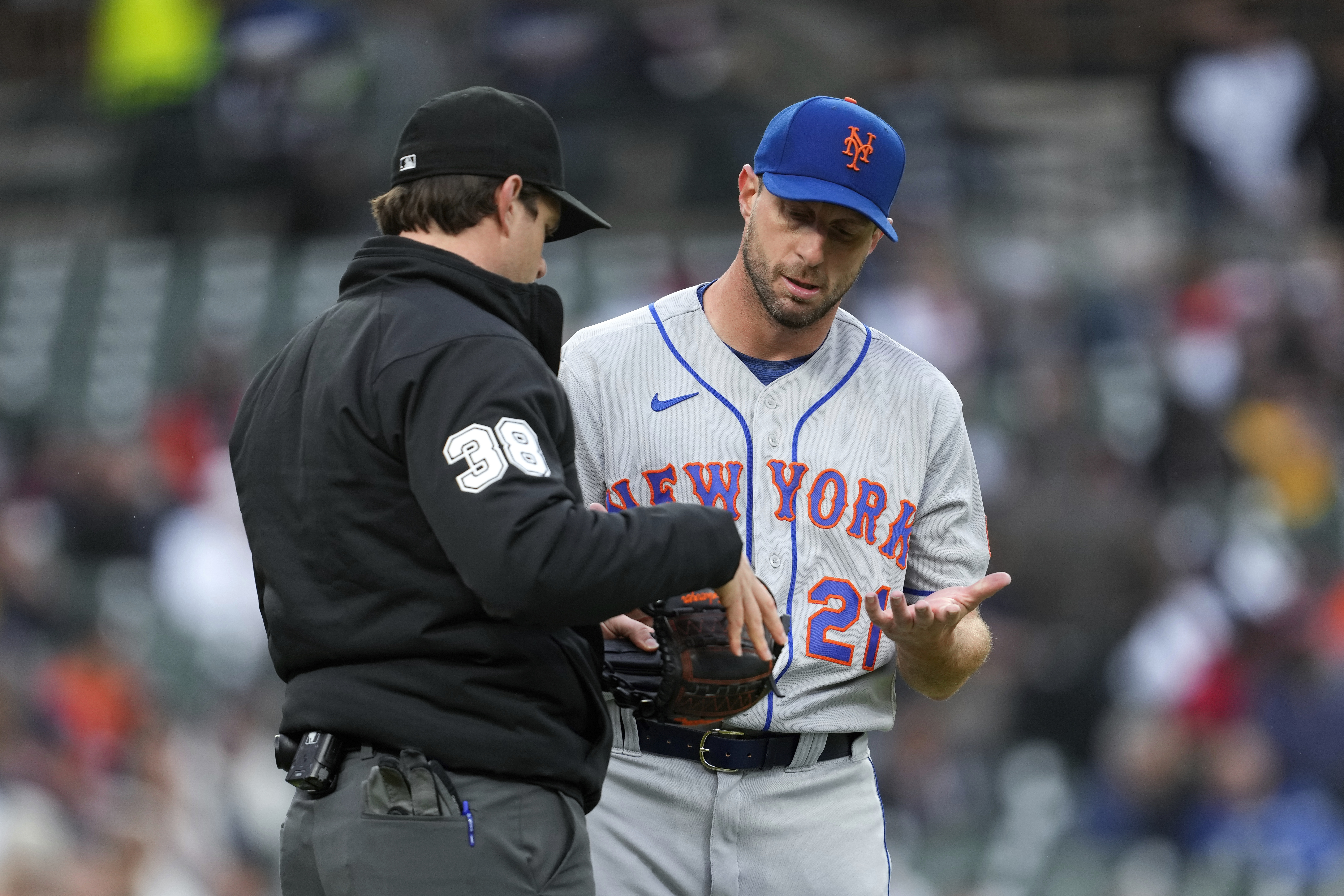 New York Mets pitcher Max Scherzer is checked by umpire Adam Beck on his way to the dugout against the Detroit Tigers after the second inning during the second baseball game of a doubleheader, Wednesday, May 3, 2023, in Detroit. (AP Photo/Paul Sancya)