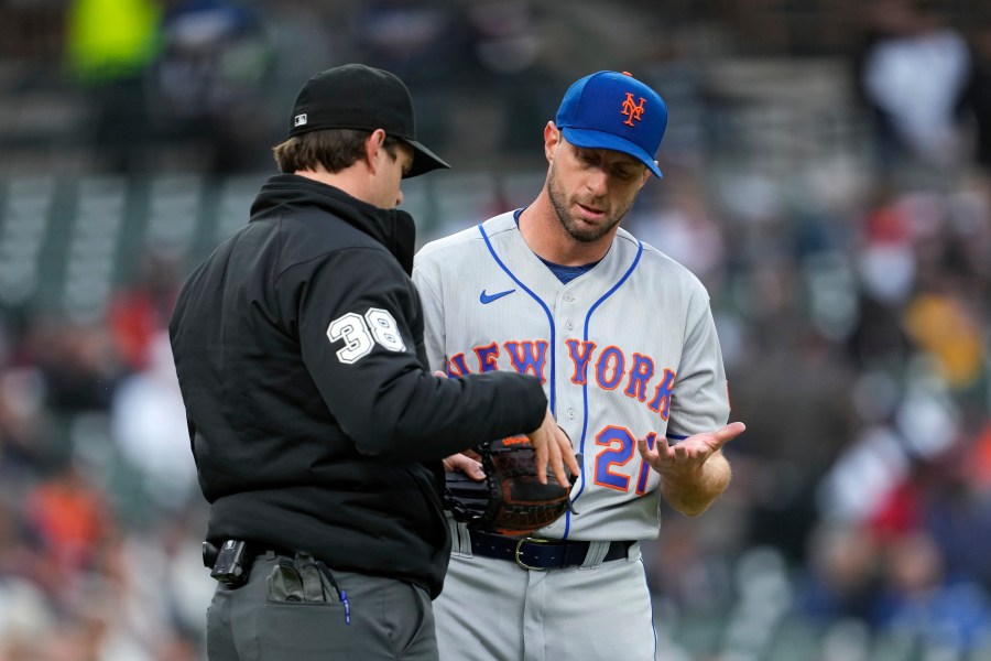 New York Mets pitcher Max Scherzer is checked by umpire Adam Beck on his way to the dugout against the Detroit Tigers after the second inning during the second baseball game of a doubleheader, Wednesday, May 3, 2023, in Detroit. (AP Photo/Paul Sancya)