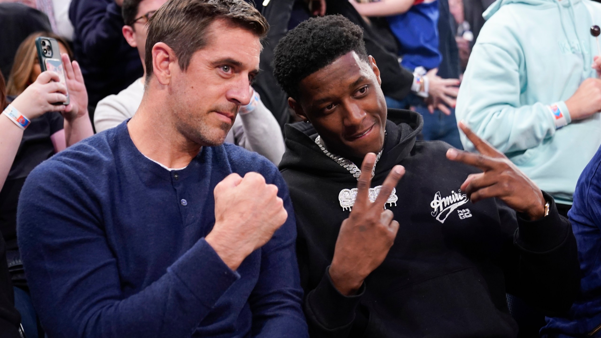 New York Jets quarterback Aaron Rodgers and cornerback Sauce Gardner sit courtside in the second half of Game 2 in the NBA basketball Eastern Conference semifinals playoff series between the New York Knicks and the Miami Heat, Tuesday, May 2, 2023, at Madison Square Garden in New York. The Knicks won 111-105. (AP Photo/Mary Altaffer)