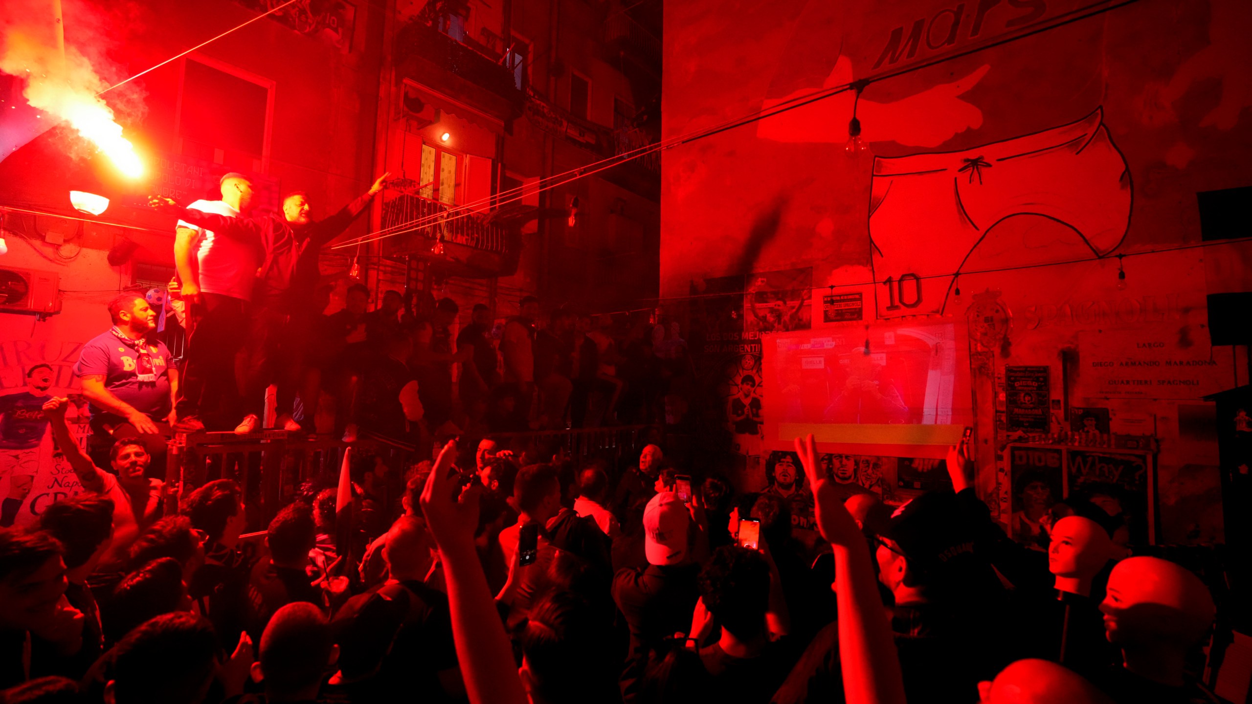 Napoli fans celebrates on the street prior to the start of Udinese Napoli Serie A soccer match, in Naples, Italy, Thursday, May 4, 2023. For the third time in five days, Napoli fans are hoping and preparing to celebrate the Italian league soccer title. (AP Photo/Andrew Medichini)