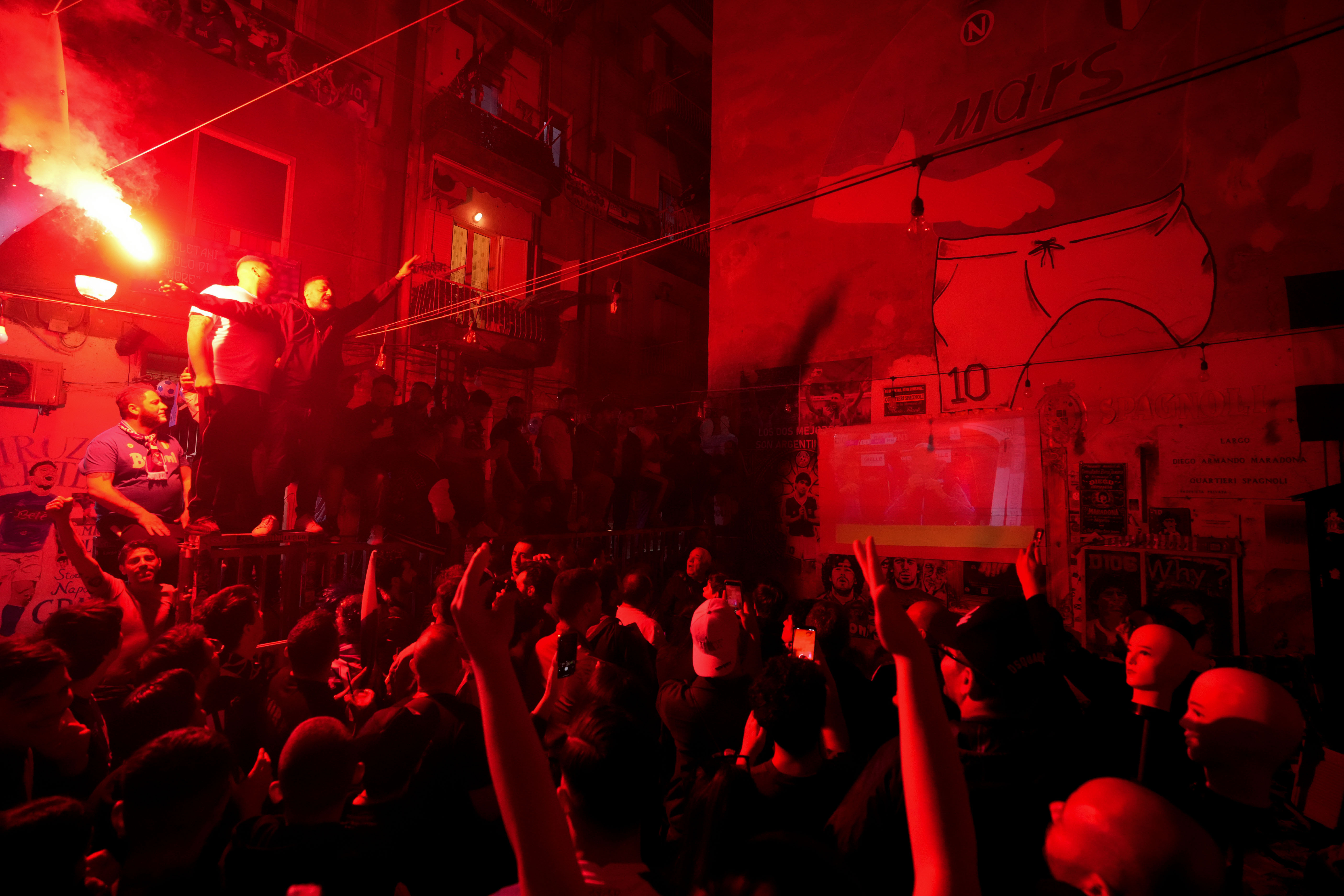 Napoli fans celebrates on the street prior to the start of Udinese Napoli Serie A soccer match, in Naples, Italy, Thursday, May 4, 2023. For the third time in five days, Napoli fans are hoping and preparing to celebrate the Italian league soccer title. (AP Photo/Andrew Medichini)