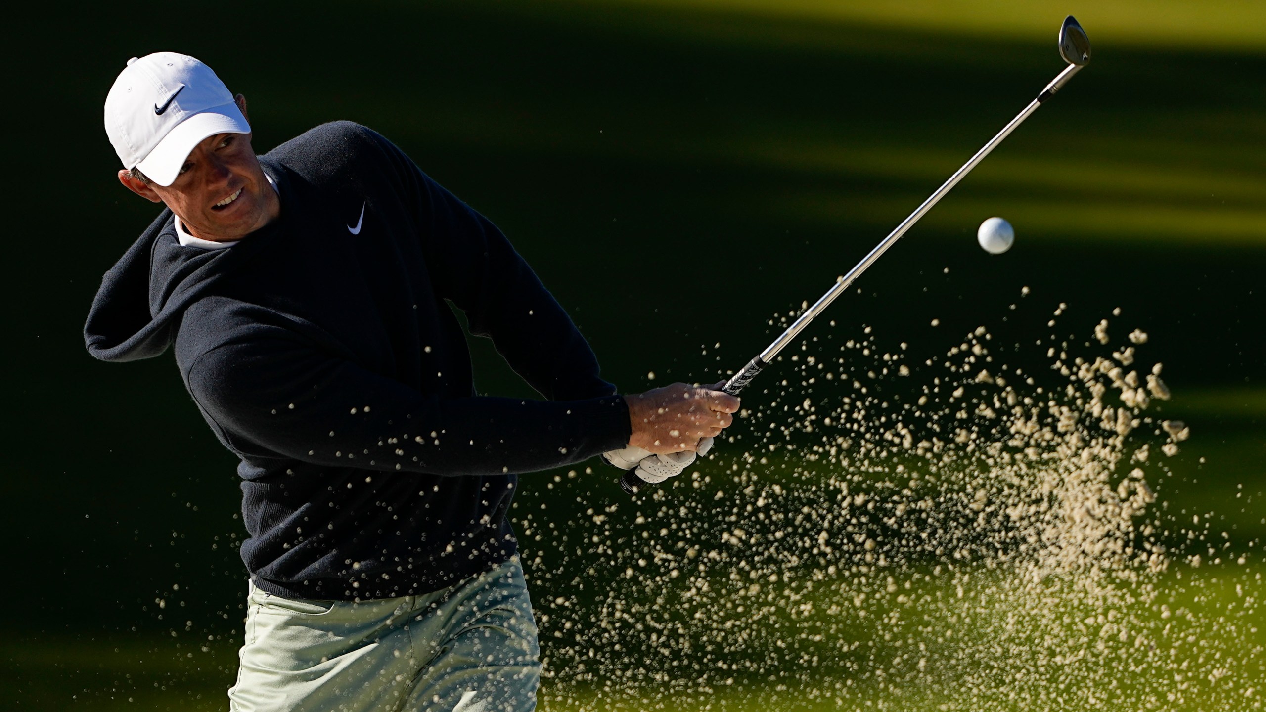 Rory McIlroy, of Northern Ireland, hits from the bunker on the 14th hole during first round of the Wells Fargo Championship golf tournament at the Quail Hollow Club on Thursday, May 4, 2023, in Charlotte, N.C. (AP Photo/Chris Carlson)