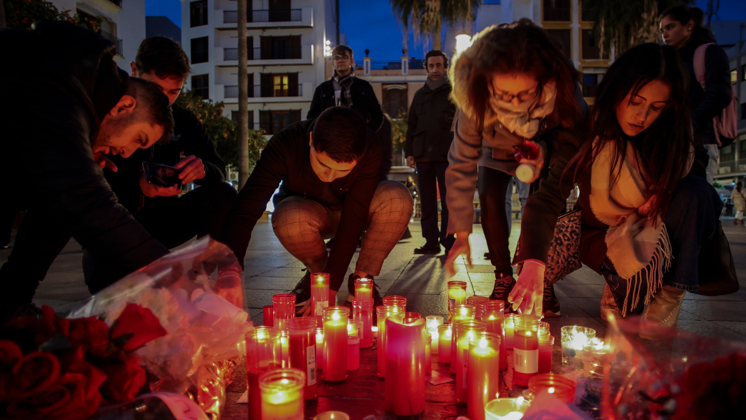 FILE - People light candles on Jan. 26, 2023, next to a memorial site for a church sacristan who was killed on Jan. 25 in Algeciras, southern Spain. Far-right groups have used Twitter to spread hate directed at Muslims and Immigrants. Many of them reference the Reconquista, the period in the Middle Ages that saw Christians retake vast parts of the Iberian peninsula from its Muslim leaders. The term has also been used by the Vox Party, a far-right party that has been praised by ex-U.S. President Donald Trump. (AP Photo/Juan Carlos Toro)