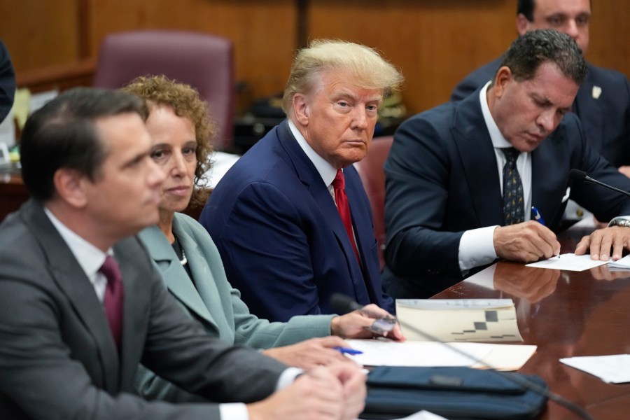 FILE - Former President Donald Trump sits at the defense table with his legal team in a Manhattan court, April 4, 2023, in New York. A judge known for his care and cautiousness in presiding over litigation in the aftermath of the 9/11 attacks was selected Friday, May 5, to decide whether Trump’s criminal case proceeds in state or federal court. (AP Photo/Seth Wenig, Pool, File)