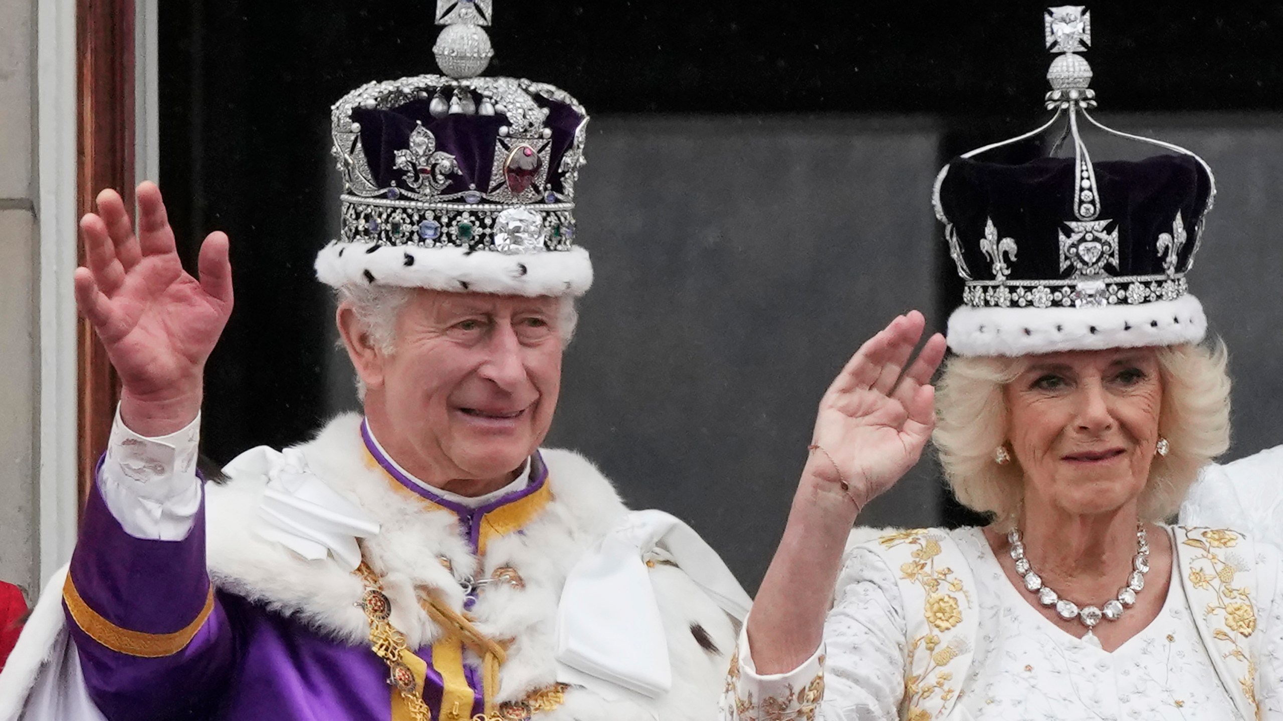 Britain's King Charles III and Queen Camilla wave to the crowds from the balcony of Buckingham Palace after the coronation ceremony in London, Saturday, May 6, 2023. (AP Photo/Frank Augstein)