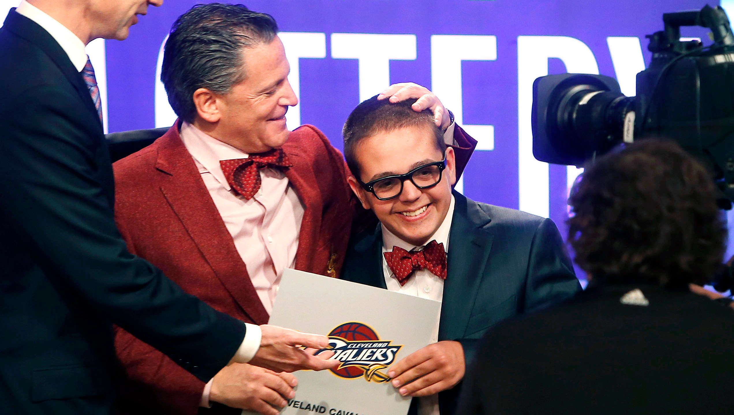 FILE - In this May 21, 2013, file photo, Cleveland Cavaliers owner Dan Gilbert congratulates his son, Nick Gilbert, after the team won the NBA basketball draft lottery in New York. Nicolas “Nick” Gilbert, who became the team's good luck charm at NBA draft lotteries, has died. He was 26. A funeral announcement posted by the Ira Kaufman Chapel said Gilbert died Saturday, May 6, 2023 “peacefully at home surrounded by family.” (AP Photo/Jason DeCrow, File)