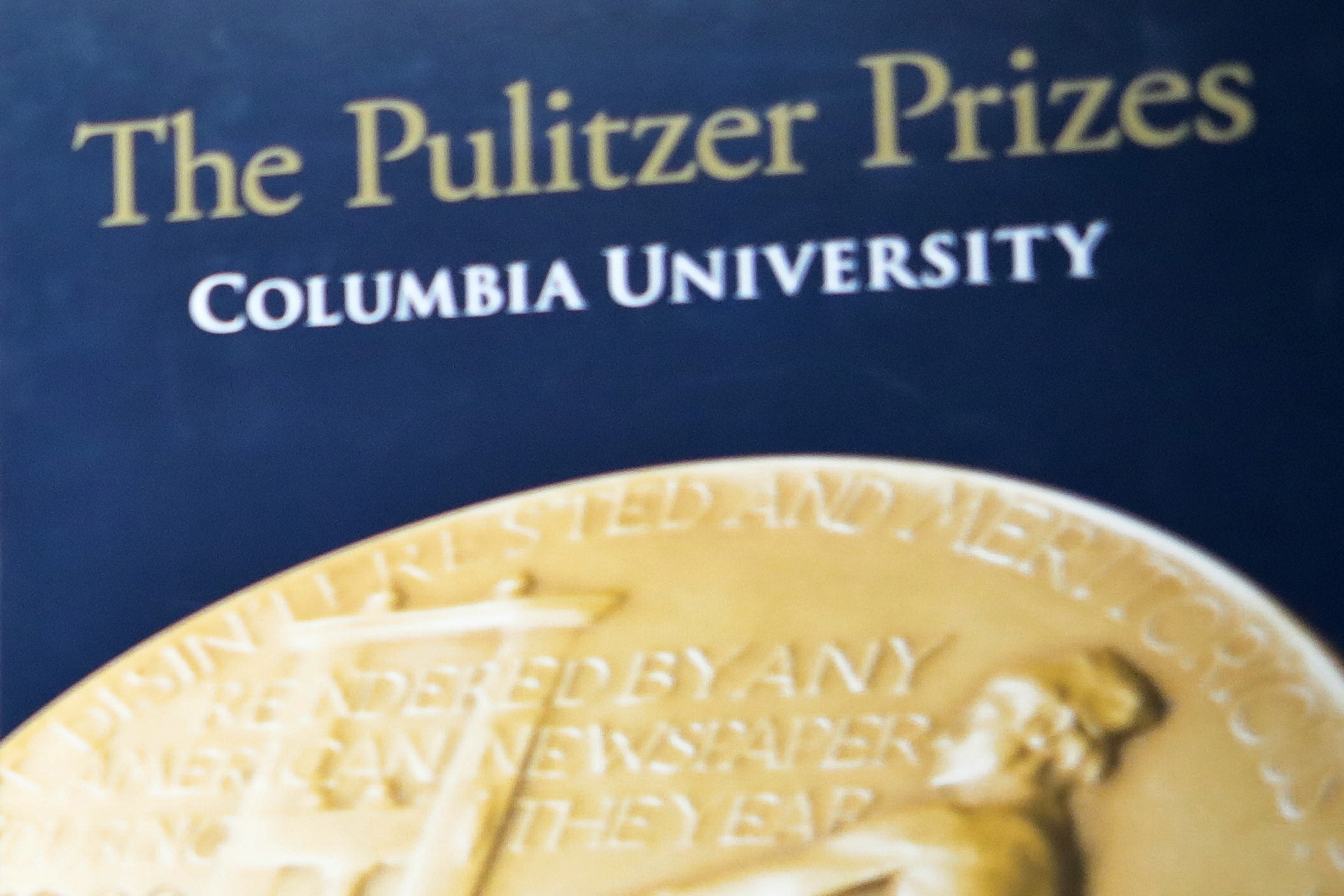 FILE - A sign for the Pulitzer Prize is shown at Columbia University, Tuesday May 28, 2019, in New York. The Pulitzer Prizes will be awarded Monday, May 8, 2023 and honor outstanding journalism during a violent year that included Russia’s brutal invasion of Ukraine, mass shootings that targeted an elementary school and supermarket and communities beset with climate change-fueled flood and flames. (AP Photo/Bebeto Matthews, File)