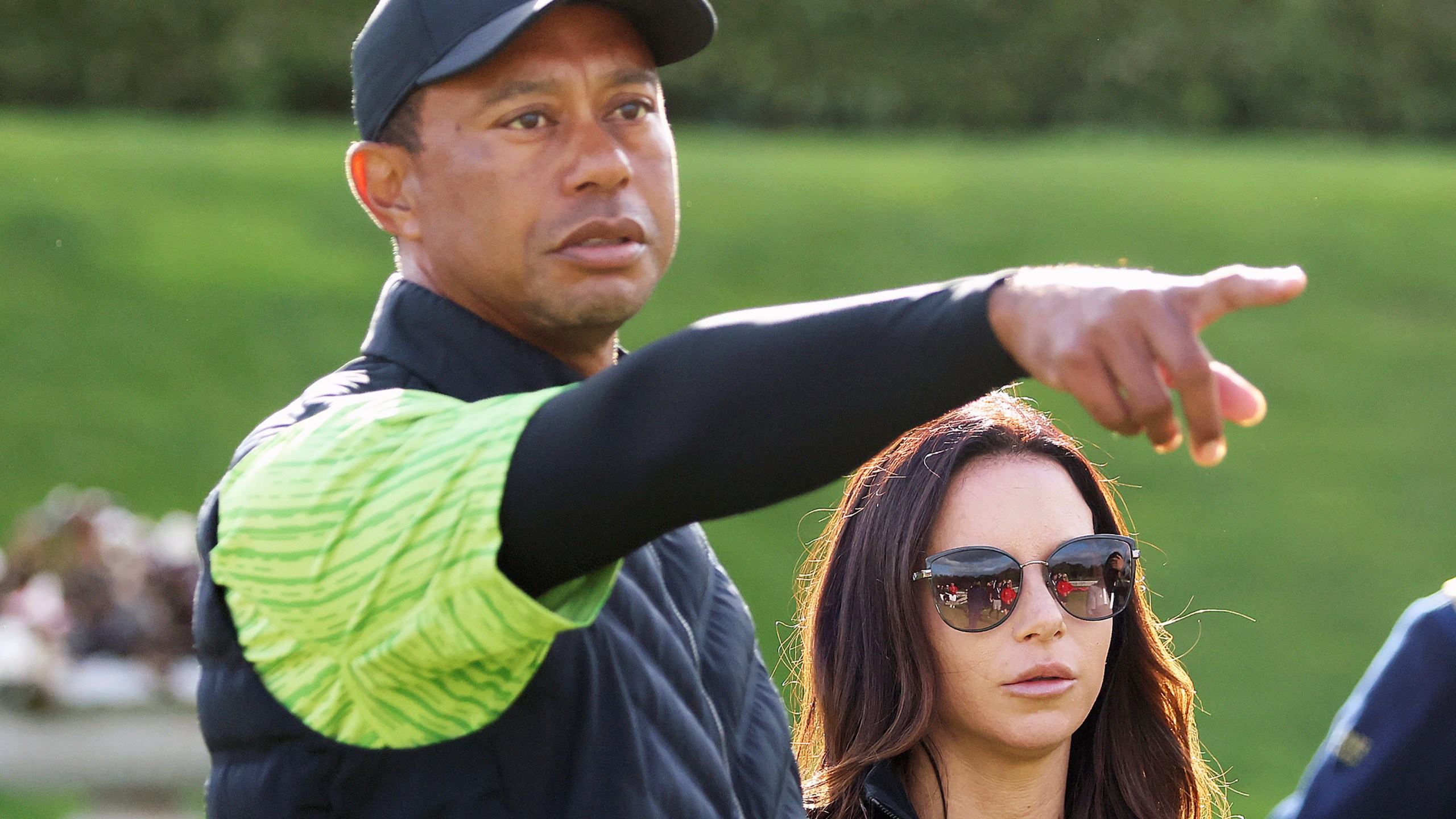 FILE - Tiger Woods and girlfriend Erica Herman on the 18th green during the JP McManus Pro-Am at Adare Manor, Limerick, Ireland, Monday, July, 4, 2022. A $30-million legal battle between Tiger Woods and his ex-girlfriend has escalated with Erica Herman accusing the golf superstar of beginning their sexual relationship when she was his employee and threatening to fire her if she didn't sign a nondisclosure agreement she now wants voided. (AP Photo/Peter Morrison, FIle)