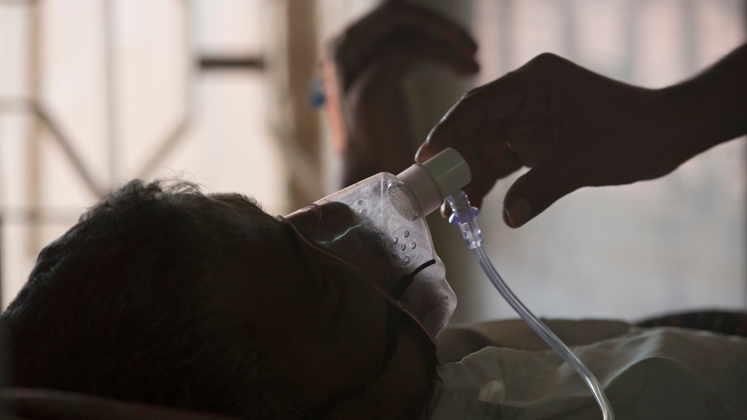 FILE - A relative adjusts the oxygen mask of a tuberculosis patient at a TB hospital on World Tuberculosis Day in Hyderabad, India, March 24, 2018. Top U.N. officials and health industry leaders are trying to tackle an alarming surge in tuberculosis, which is now killing more people worldwide than COVID-19 or AIDS. Among the problems: a high number of cases in conflict zones, including Ukraine and Sudan, where it’s difficult to track down people with the disease and diagnose new sufferers. (AP Photo/Mahesh Kumar A., File)