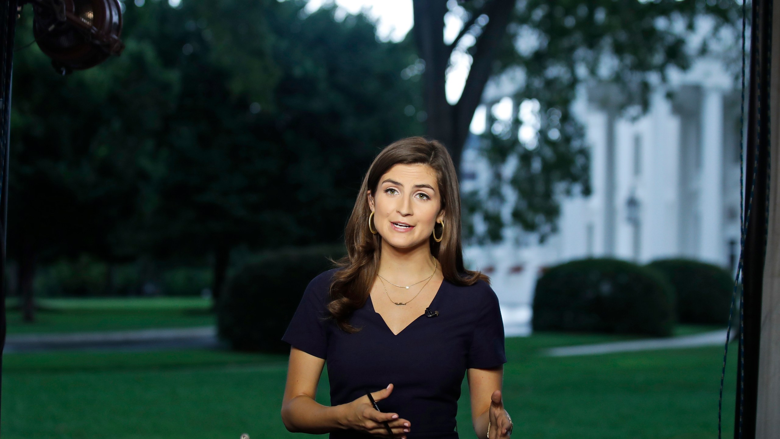 FILE - CNN White House correspondent Kaitlan Collins during a live shot in front of the White House in Washington, July 25, 2018. Donald Trump's town hall forum on CNN on Wednesday, May 10, 2023, is the first major TV event of the 2024 presidential campaign, and a big test for the chosen moderator, Kaitlan Collins. The former White House correspondent and now-morning show host must juggle questions from an audience of Republican primary voters, her own follow-ups and the need to fact-check false statements. (AP Photo/Alex Brandon, File)