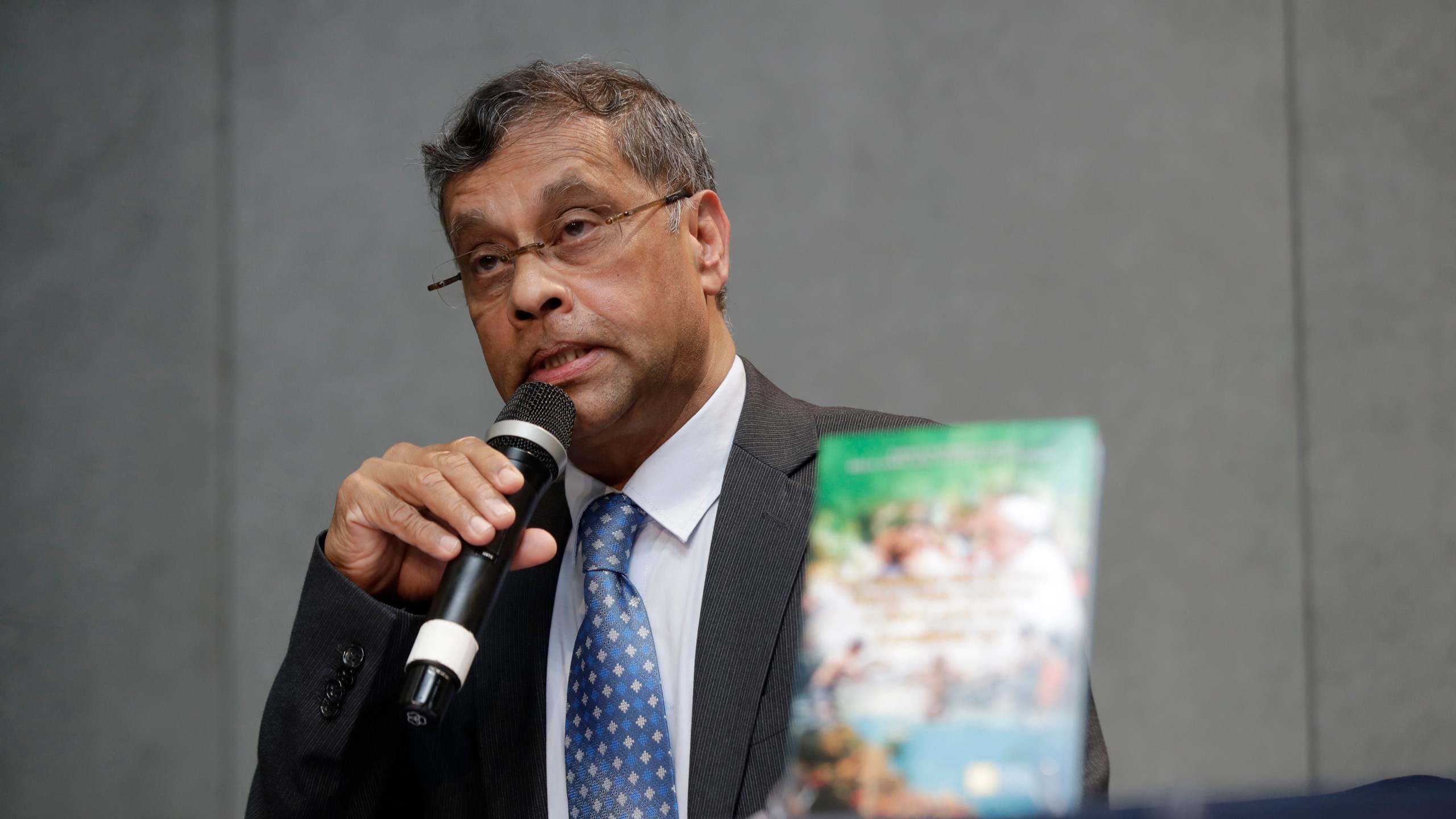 FILE - Aloysius John, Secretary General of Caritas Internationalis, speaks during a press conference to present a document on the 5th anniversary of Pope Francis' encyclical "Laudato si" (Praise Be) calling on the world to act to stop the human destruction of the planet, at the Vatican's press room, Thursday, June 18, 2020. The recently ousted head of the Vatican's main charitable organization is breaking six months of silence to denounce his removal as a “brutal power grab.” Aloysius John has penned an eight-page open letter to the Caritas confederation on the eve of a General Assembly, from May 11, 2023 to May 16, to elect his successor. (AP Photo/Alessandra Tarantino, File)