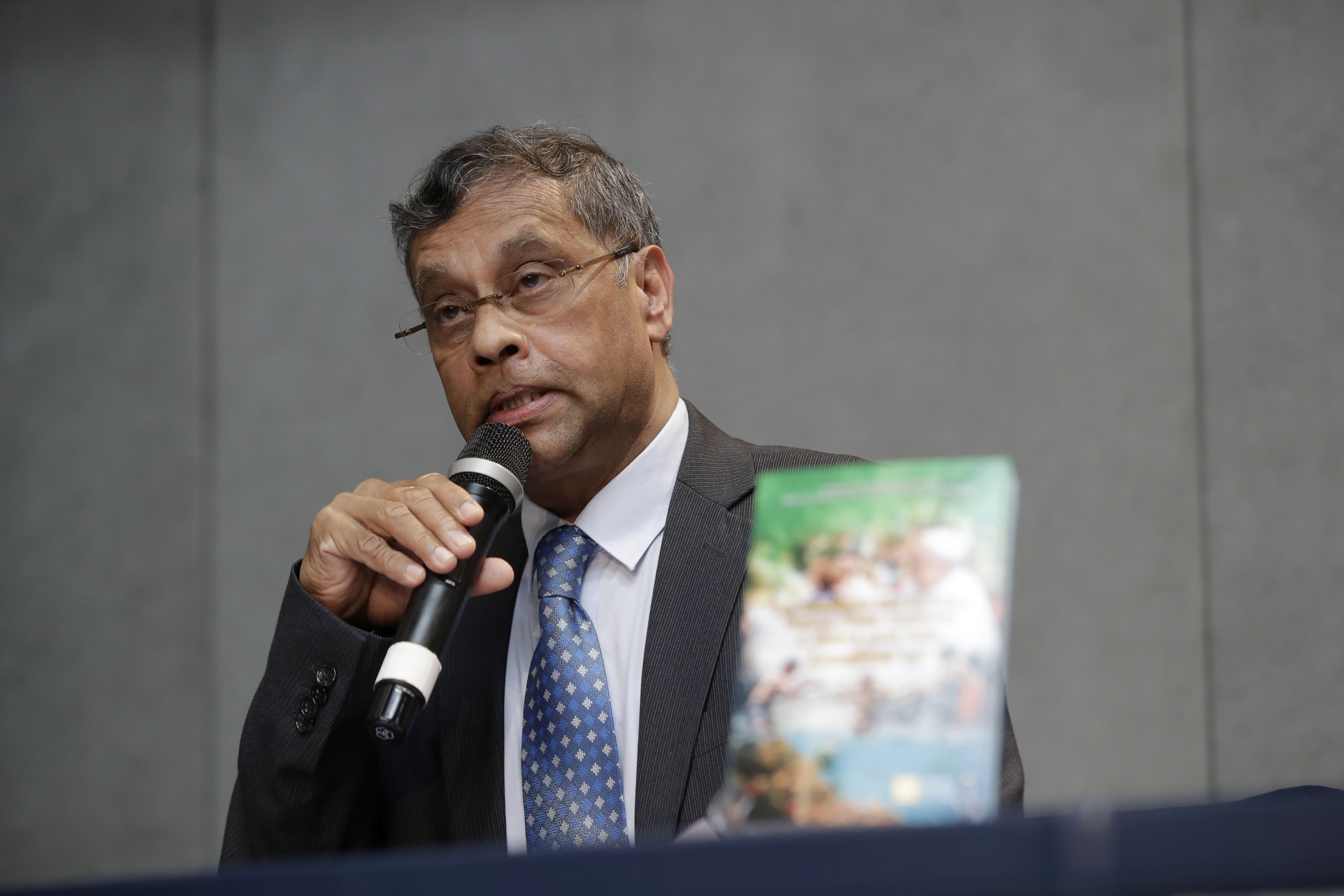 FILE - Aloysius John, Secretary General of Caritas Internationalis, speaks during a press conference to present a document on the 5th anniversary of Pope Francis' encyclical "Laudato si" (Praise Be) calling on the world to act to stop the human destruction of the planet, at the Vatican's press room, Thursday, June 18, 2020. The recently ousted head of the Vatican's main charitable organization is breaking six months of silence to denounce his removal as a “brutal power grab.” Aloysius John has penned an eight-page open letter to the Caritas confederation on the eve of a General Assembly, from May 11, 2023 to May 16, to elect his successor. (AP Photo/Alessandra Tarantino, File)