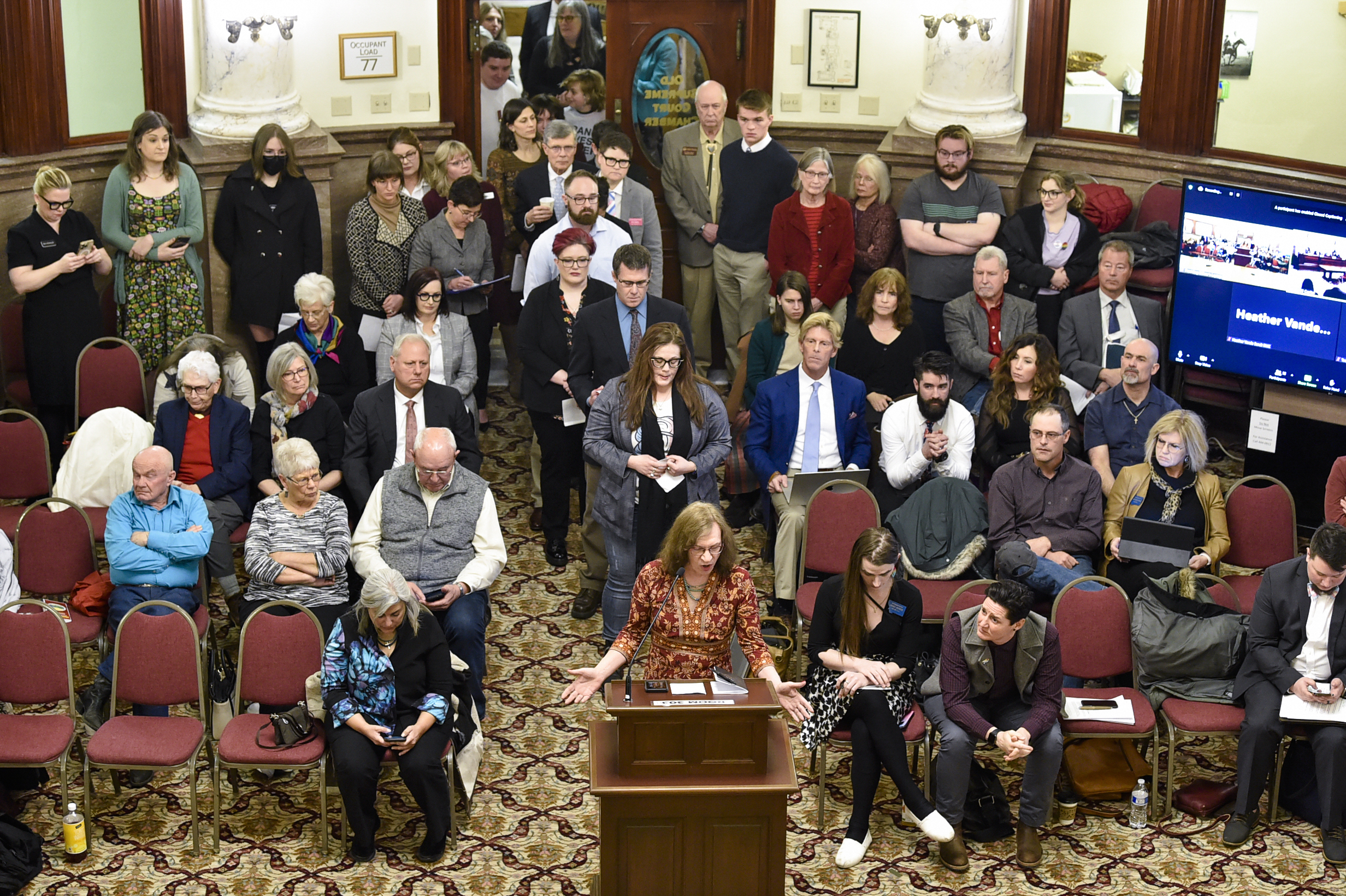 FILE - Opponents of a Montana bill banning gender-affirming medical care for transgender minors line up out the door of the Senate Judiciary Committee, Jan. 27, 2023, at the state Capitol in Helena, Mont. Two transgender children, their parents and two health care providers filed a lawsuit Tuesday, May 9, arguing that the Montana law that would ban gender-affirming care for transgender youth is unconstitutional. (Thom Bridge/Independent Record via AP, File)