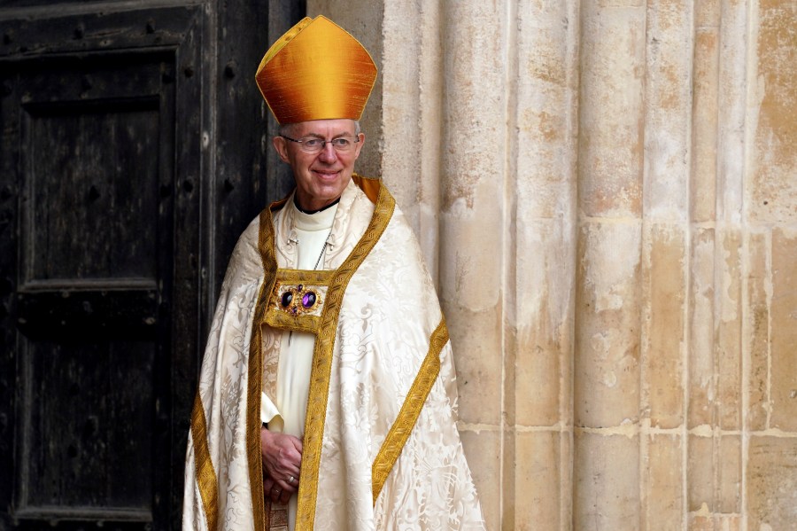 FILE - Archbishop of Canterbury Justin Welby stands at the entrance of Westminster Abbey ahead of the coronation of King Charles III and Camilla, the Queen Consort, in London, Saturday, May 6, 2023. The head of the Church of England on Wednesday, May 10, 2023, condemned a British government bill that would dramatically curb migrants’ ability to seek asylum in the U.K., calling the policy “isolationist, morally unacceptable and politically impractical.” (Andrew Milligan/Pool via AP, File)