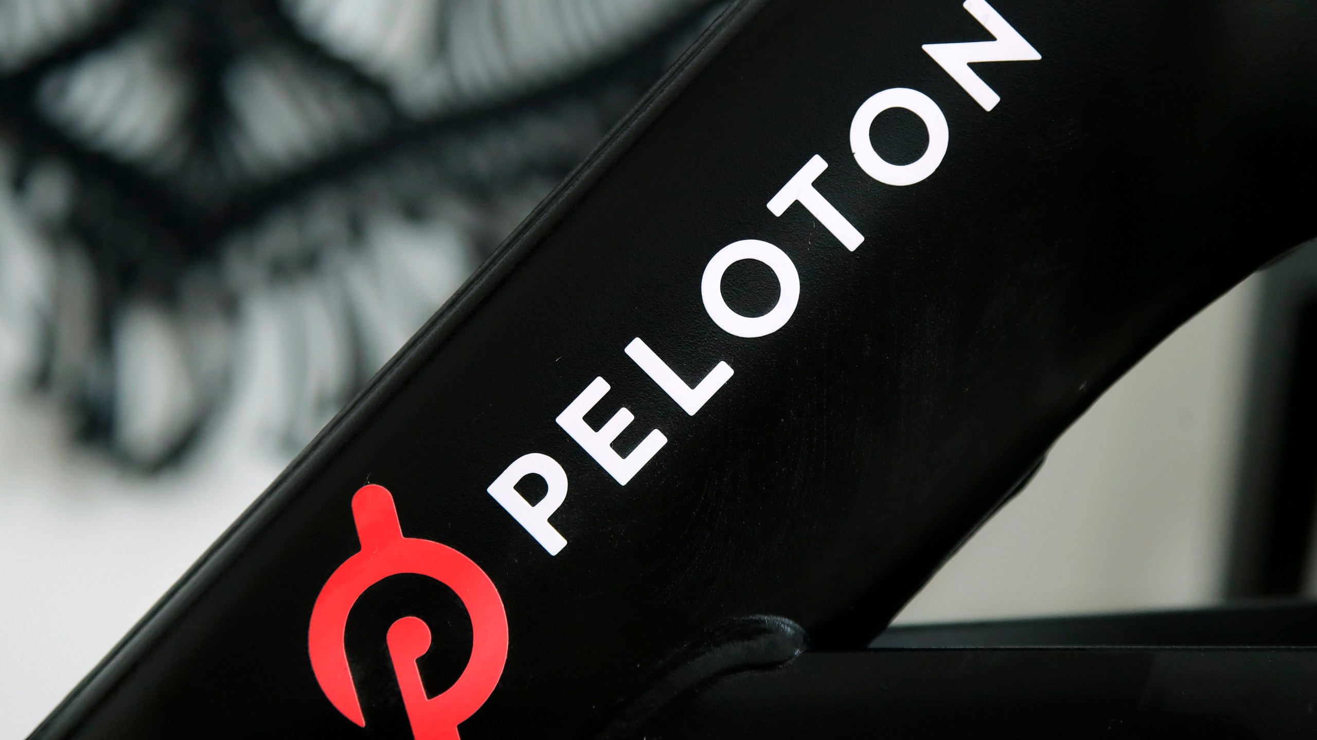 FILE - A Peloton logo is seen on the company's stationary bicycle on Nov. 19, 2019, in San Francisco, Calif. Peloton is recalling more than 2 million of its exercise bikes because the bike’s seat post assembly can break during use, posing fall and injury hazards. (AP Photo/Jeff Chiu, File)