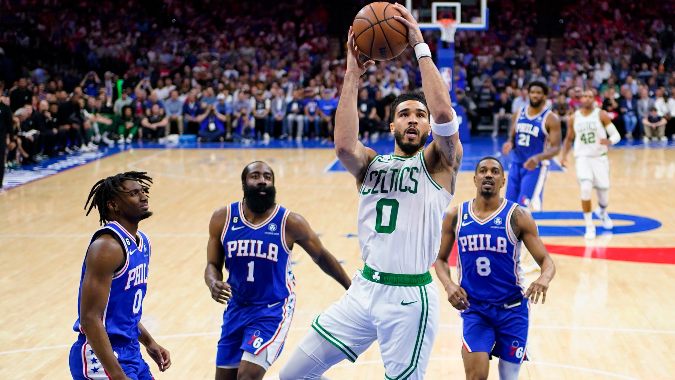 Boston Celtics' Jayson Tatum (0) shoots against Philadelphia 76ers' Tyrese Maxey (0), James Harden (1), and De'Anthony Melton (8) during the first half of Game 6 of an NBA basketball playoffs Eastern Conference semifinal, Thursday, May 11, 2023, in Philadelphia. (AP Photo/Matt Slocum)