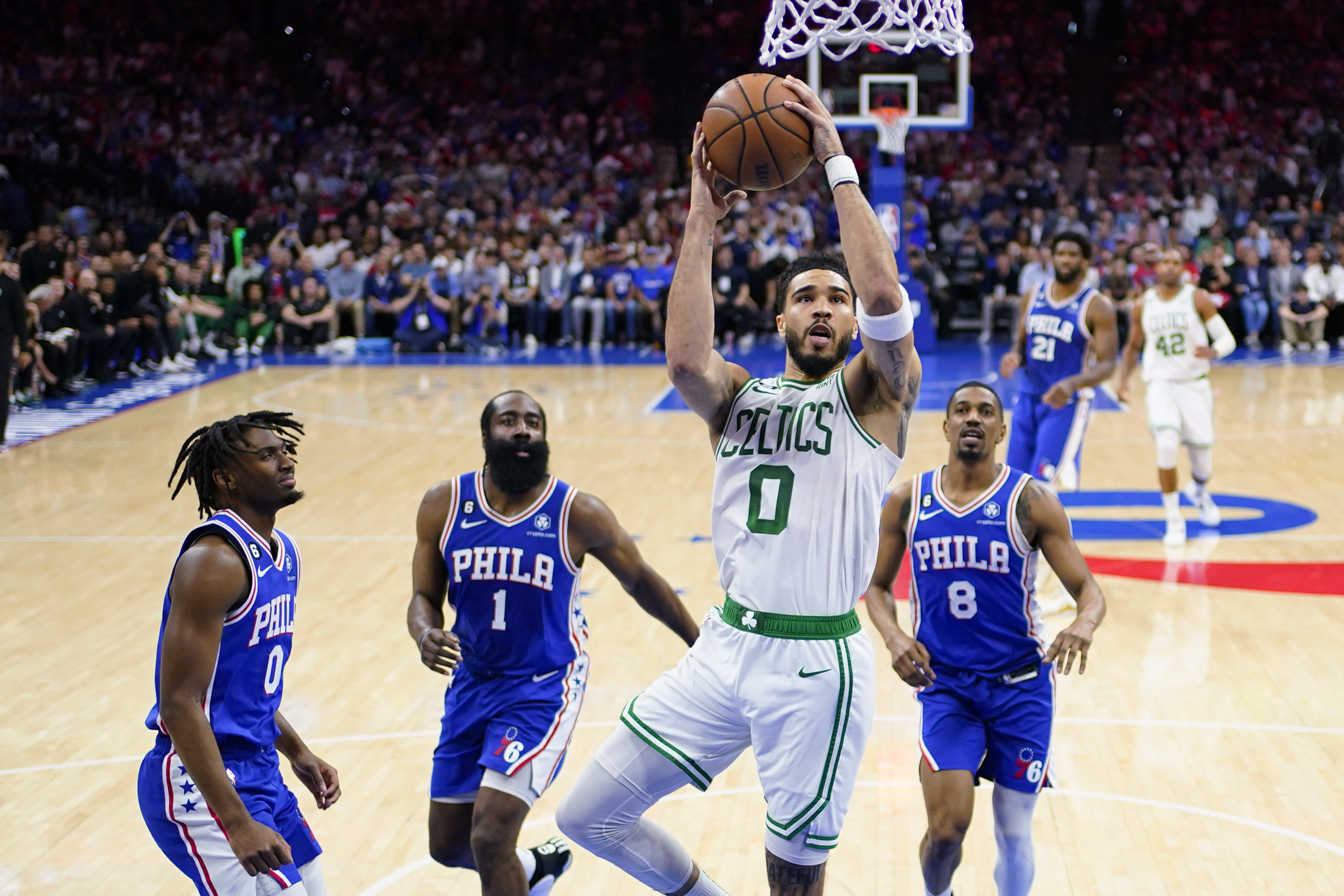 Boston Celtics' Jayson Tatum (0) shoots against Philadelphia 76ers' Tyrese Maxey (0), James Harden (1), and De'Anthony Melton (8) during the first half of Game 6 of an NBA basketball playoffs Eastern Conference semifinal, Thursday, May 11, 2023, in Philadelphia. (AP Photo/Matt Slocum)