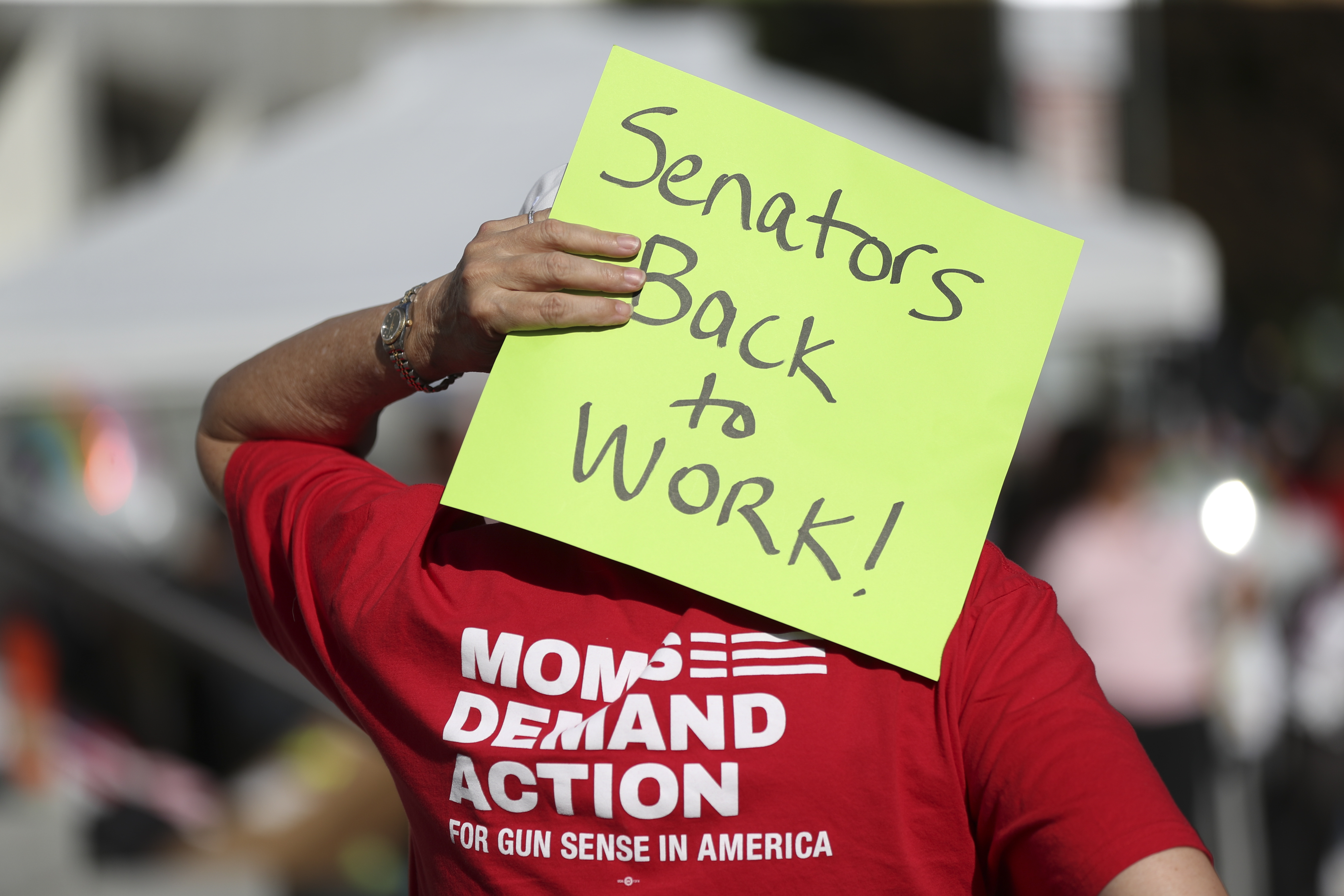 An attendee holds a sign behind their head during a rally calling for an end to the Senate Republican walkout at the Oregon State Capitol in Salem, Ore., Thursday, May 11, 2023. (AP Photo/Amanda Loman)