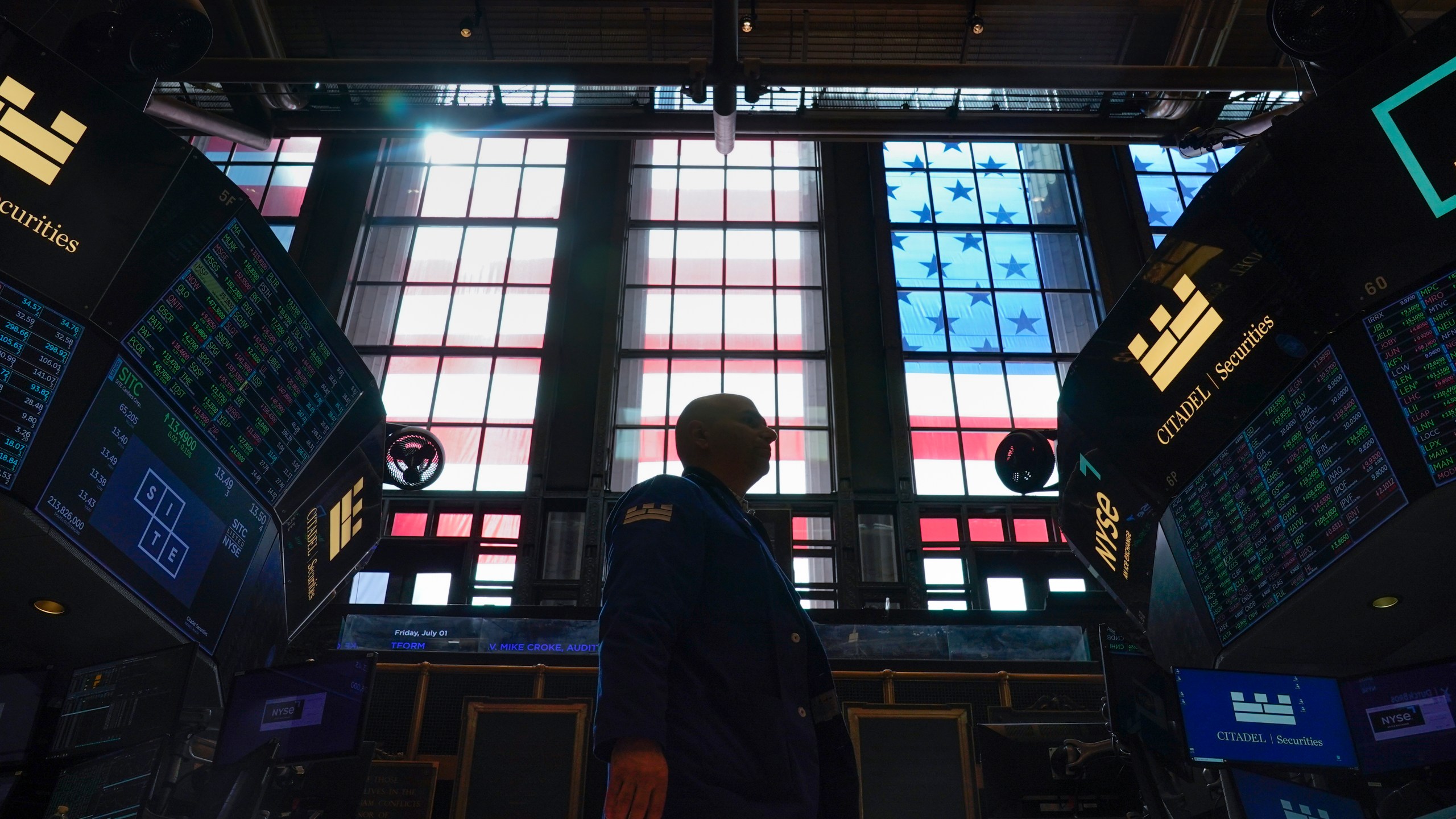 FILE - Traders work on the floor at the New York Stock Exchange in New York, Friday, July 1, 2022. (AP Photo/Seth Wenig, File)