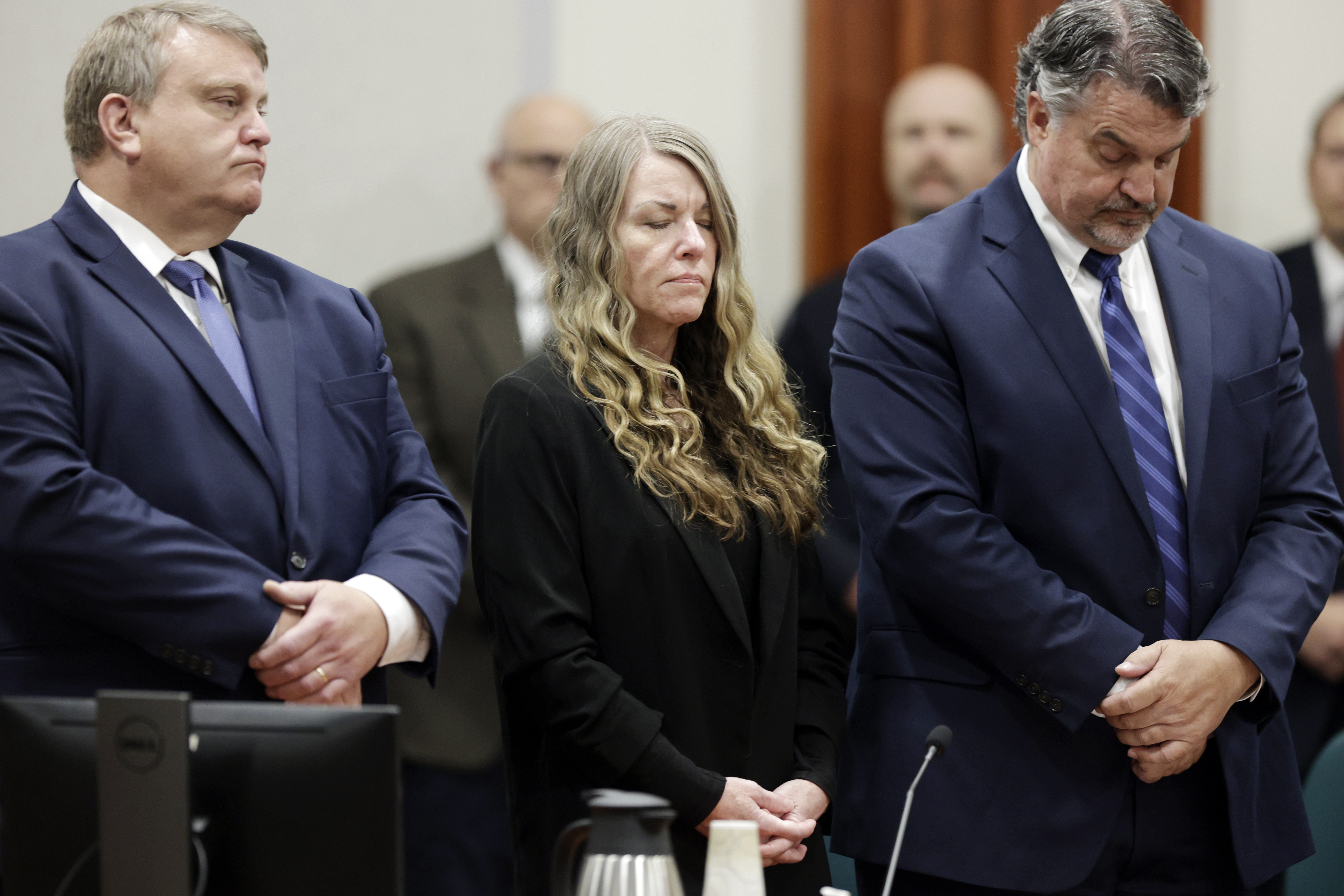 Lori Vallow Daybell stands and listens as the jury's verdict is read at the Ada County Courthouse in Boise, Idaho on Friday May 12, 2023. The Idaho jury convicted Daybell of murder in the deaths of her two youngest children and a romantic rival, a verdict that marks the end of a three-year investigation that included bizarre claims of zombie children, apocalyptic prophesies and illicit affairs. (AP Photo/Kyle Green)