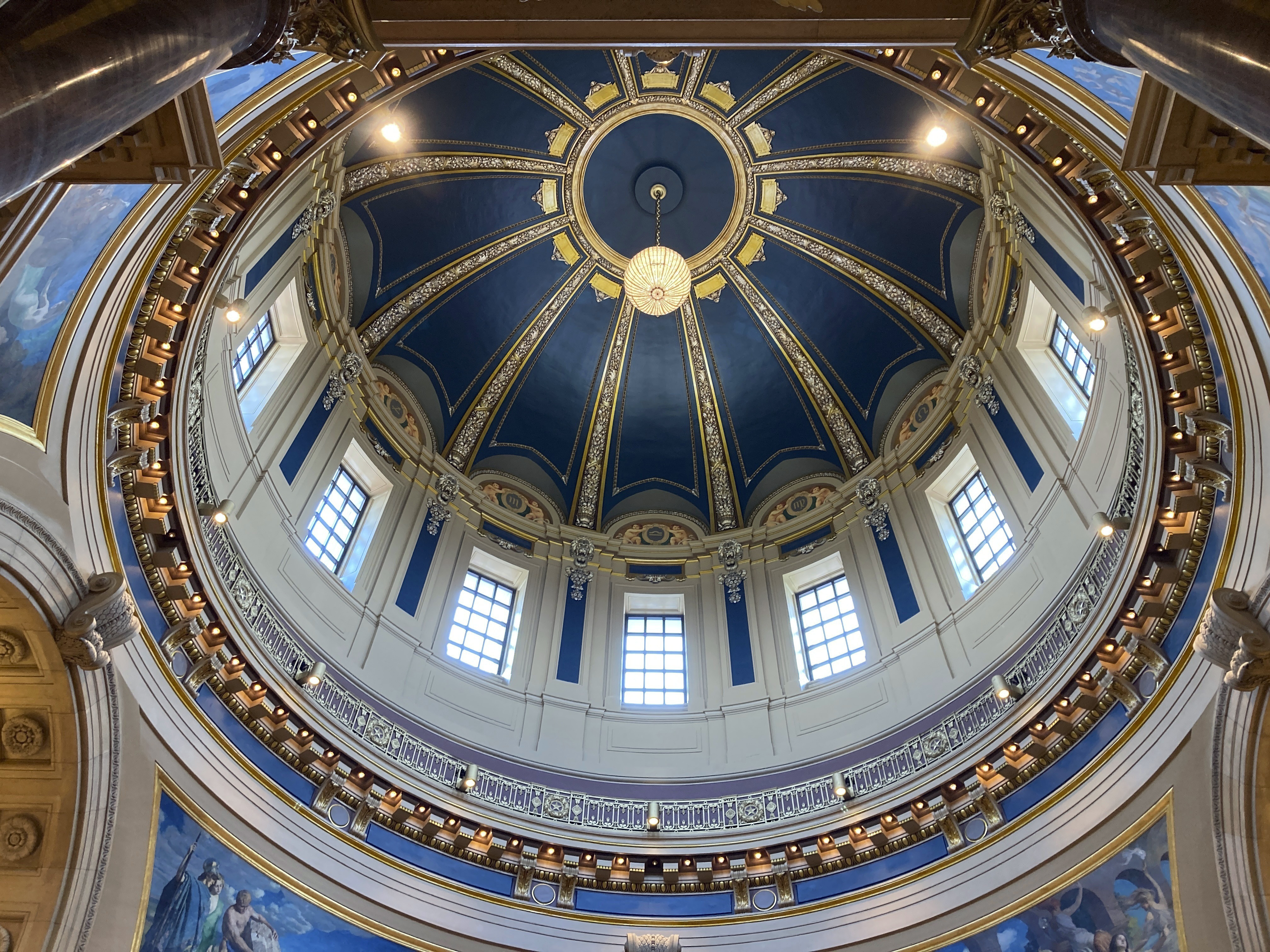 The "electrolier" is lit in the Minnesota State Capitol dome in St. Paul, Minn., Thursday, May 11, 2023, to mark Statehood Day, Minnesota's 165th birthday. The electrolier," an old term for "electric chandelier," is over 100 years old, dating from when electricity was new. It measures 6 feet in diameter, contains 92 light bulbs and hangs over 140 feet above the floor in the Capitol Rotunda. It's lit only on special occasions, such as the annual Statehood Day or on the first days of legislative sessions. (AP Photo/Steve Karnowski)