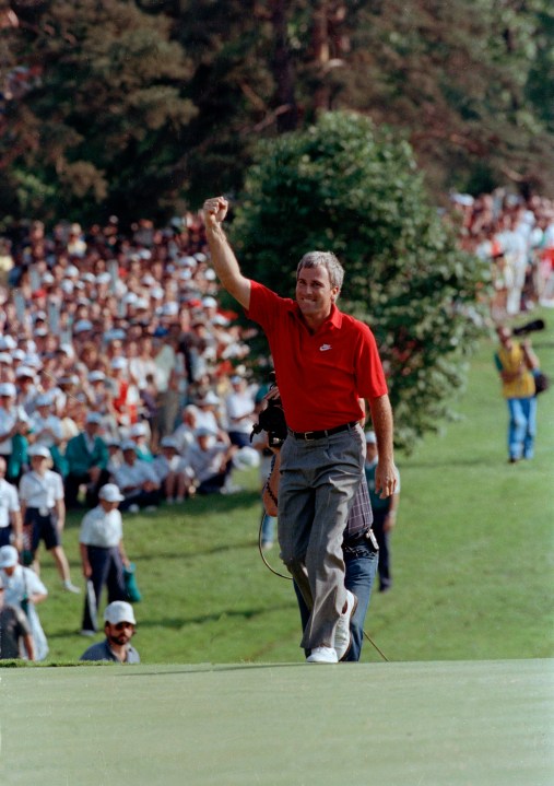 FILE- Curtis Strange reaches the 18th green waving to the crowd as he is about to win the U.S. Open for the second straight year, June 18, 1989, at the Oak Hill Country Club in Rochester, N.Y. Strange returns to Oak Hill for the PGA Championship on May 18-21 as part of the ESPN broadcast team. (AP Photo/Tom Kilips)